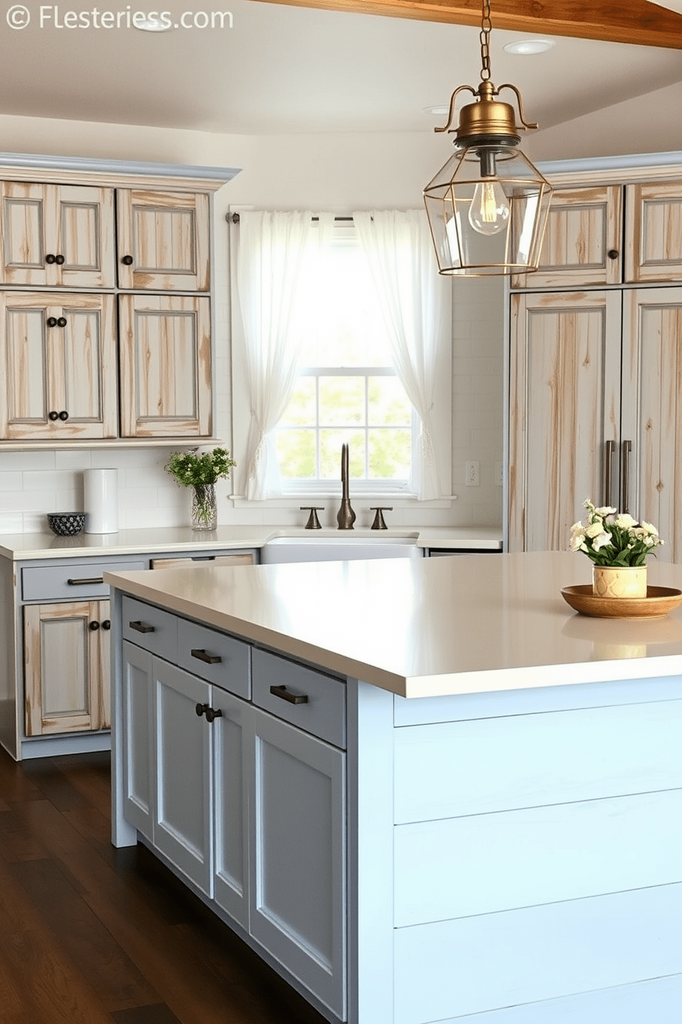 A light blue and white farmhouse style kitchen features rustic wooden cabinetry with a distressed finish. The countertops are a creamy white quartz, and a large farmhouse sink sits beneath a window adorned with sheer white curtains. A central island is topped with a light blue shiplap, providing additional workspace and seating. Vintage-style pendant lights hang above the island, adding warmth to the airy space.