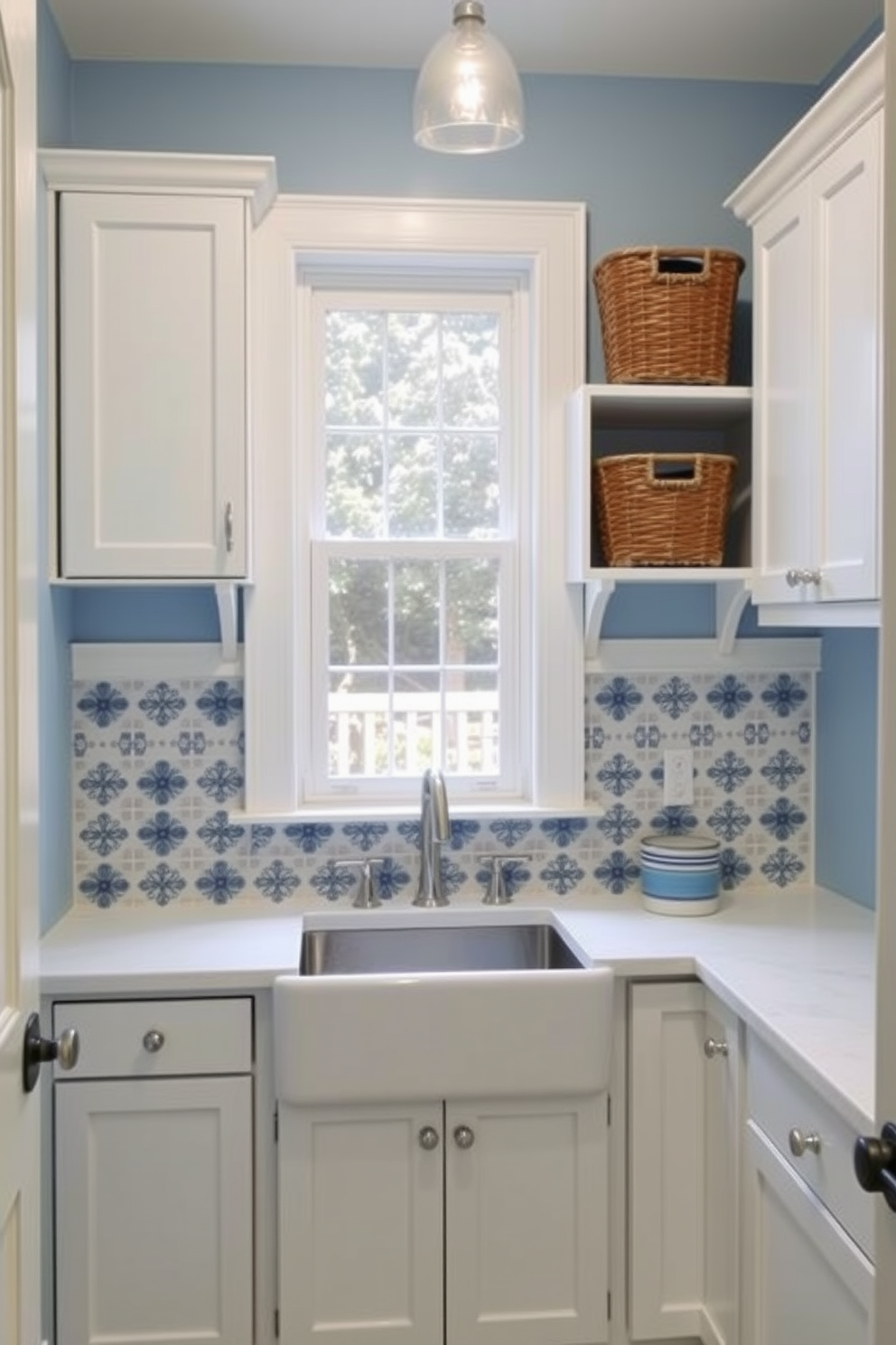 A charming laundry room featuring a classic blue and white color scheme. The walls are painted in a soft blue hue, complemented by white cabinetry and countertops. A farmhouse sink sits beneath a window, with blue and white patterned tiles adorning the backsplash. Decorative baskets in varying shades of blue are neatly arranged on the shelves, adding both style and functionality.