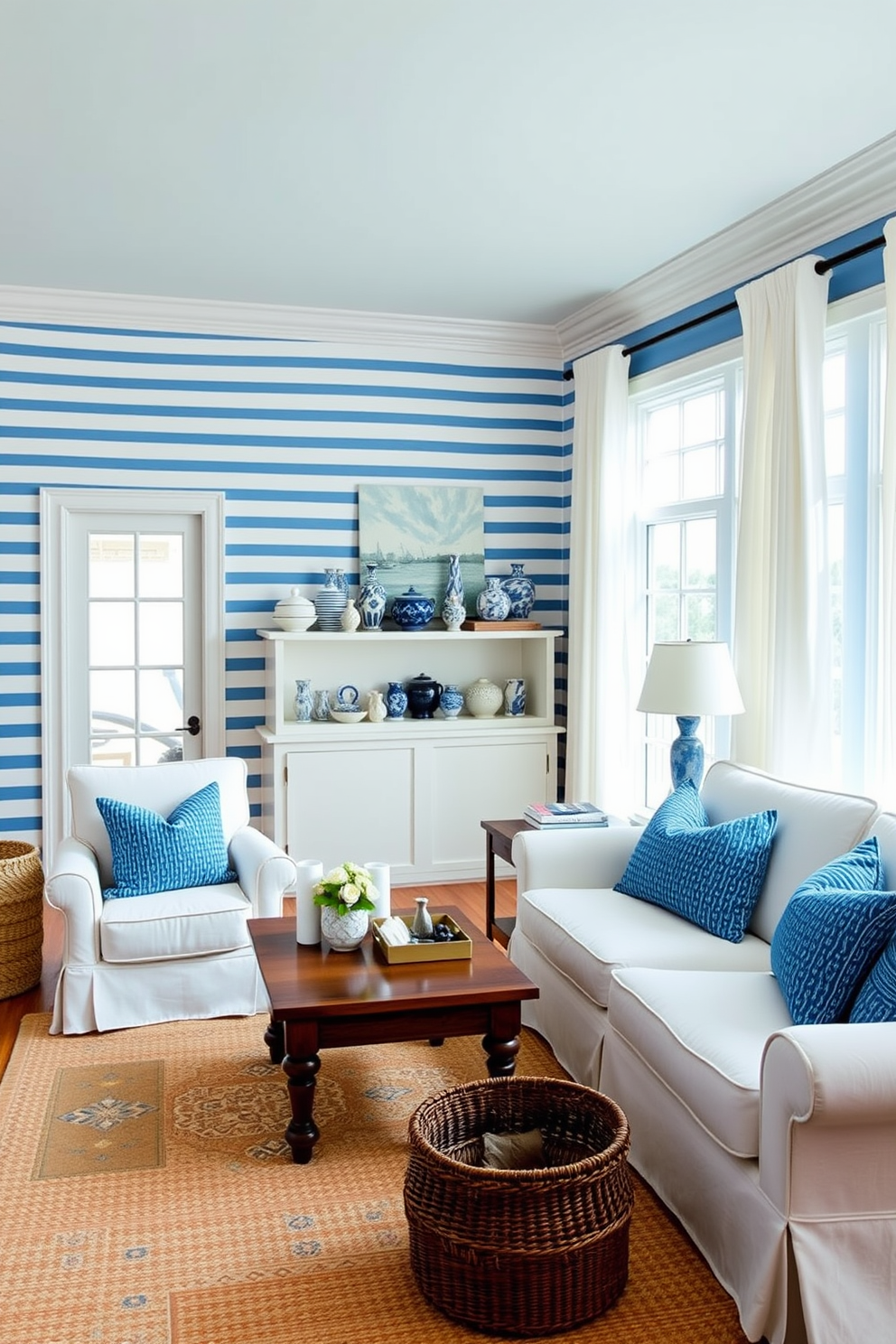 A serene living room featuring blue and white striped wallpaper that adds a nautical touch to the space. The room is furnished with a plush white sofa adorned with blue throw pillows, complemented by a wooden coffee table and a cozy area rug. Natural light floods the room through large windows dressed with sheer white curtains. A collection of blue and white ceramics is displayed on a shelf, enhancing the coastal aesthetic of the design.