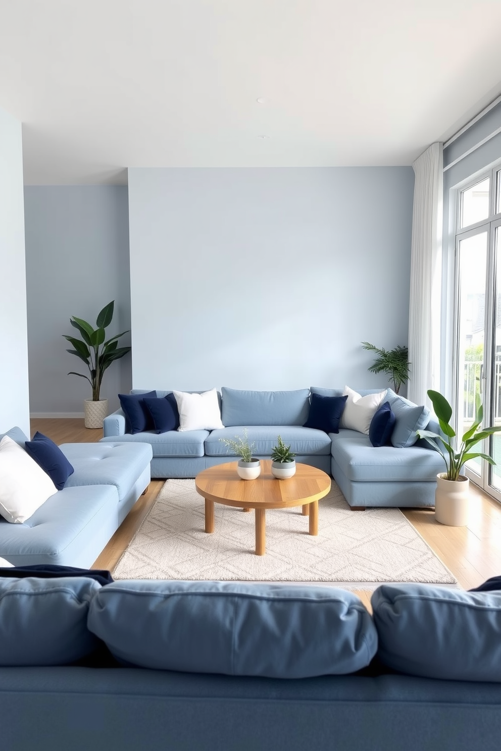 A serene living room with soft blue tones creates a tranquil atmosphere. The walls are painted in a light sky blue, and plush furniture in varying shades of blue invites relaxation. A large sectional sofa is adorned with white and navy accent pillows. A round coffee table made of natural wood sits in the center, complemented by a soft area rug in a subtle geometric pattern. Floor-to-ceiling windows allow natural light to flood the space, enhancing the calming blue hues. Decorative plants in ceramic pots add a touch of greenery and freshness to the room.