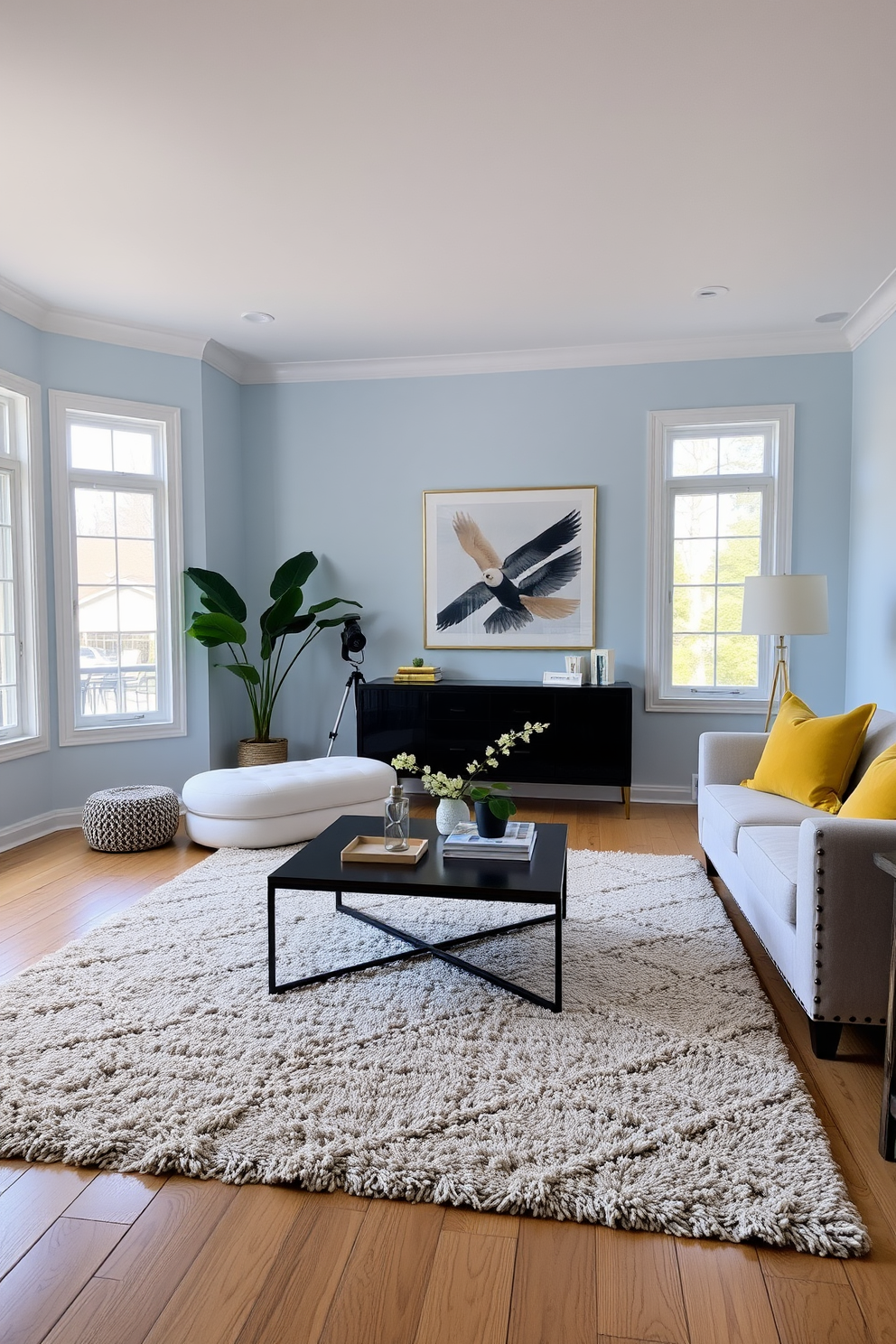 A serene living room featuring soft pastel blue walls complemented by yellow accent pillows on a plush sofa. A stylish coffee table sits in the center, surrounded by a cozy area rug, while large windows allow natural light to fill the space.