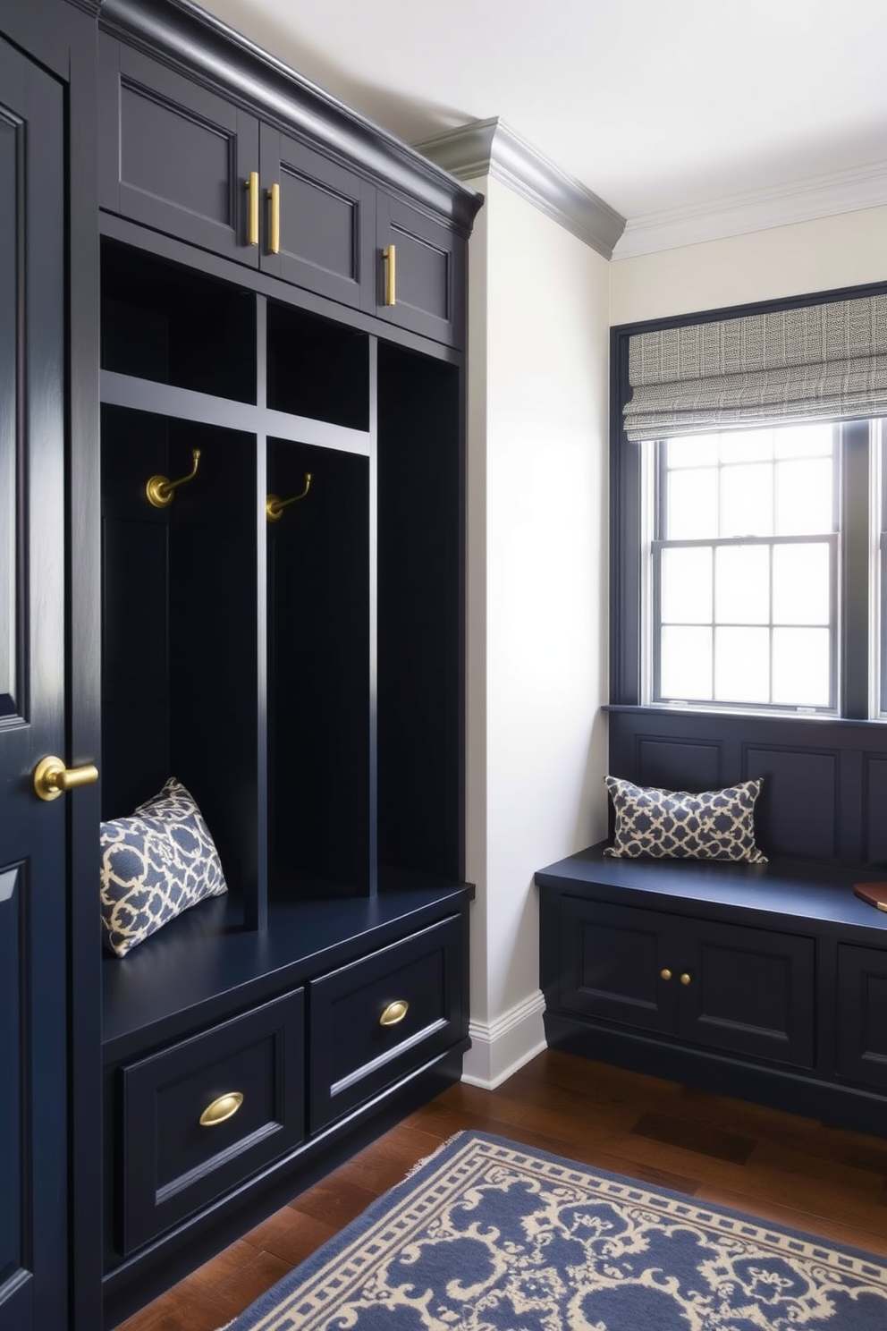 A stylish mudroom features navy built-ins adorned with elegant brass accents. The space is designed with a functional bench and hooks for coats, complemented by a patterned rug on the floor.