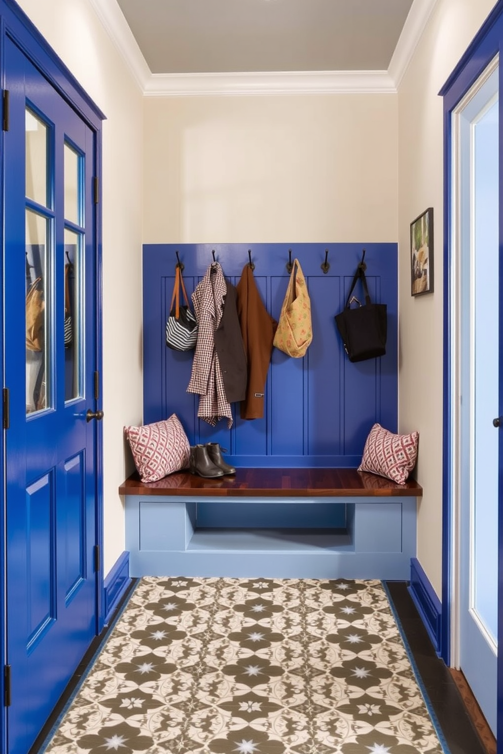 A bold blue door serves as the focal point of the mudroom, inviting guests into a vibrant and functional space. The floor is adorned with patterned tiles that add visual interest and complement the rich color of the door. The walls are painted in a soft neutral tone to create a warm and welcoming atmosphere. A built-in bench with storage underneath provides a practical seating area, while hooks above keep coats and bags organized.