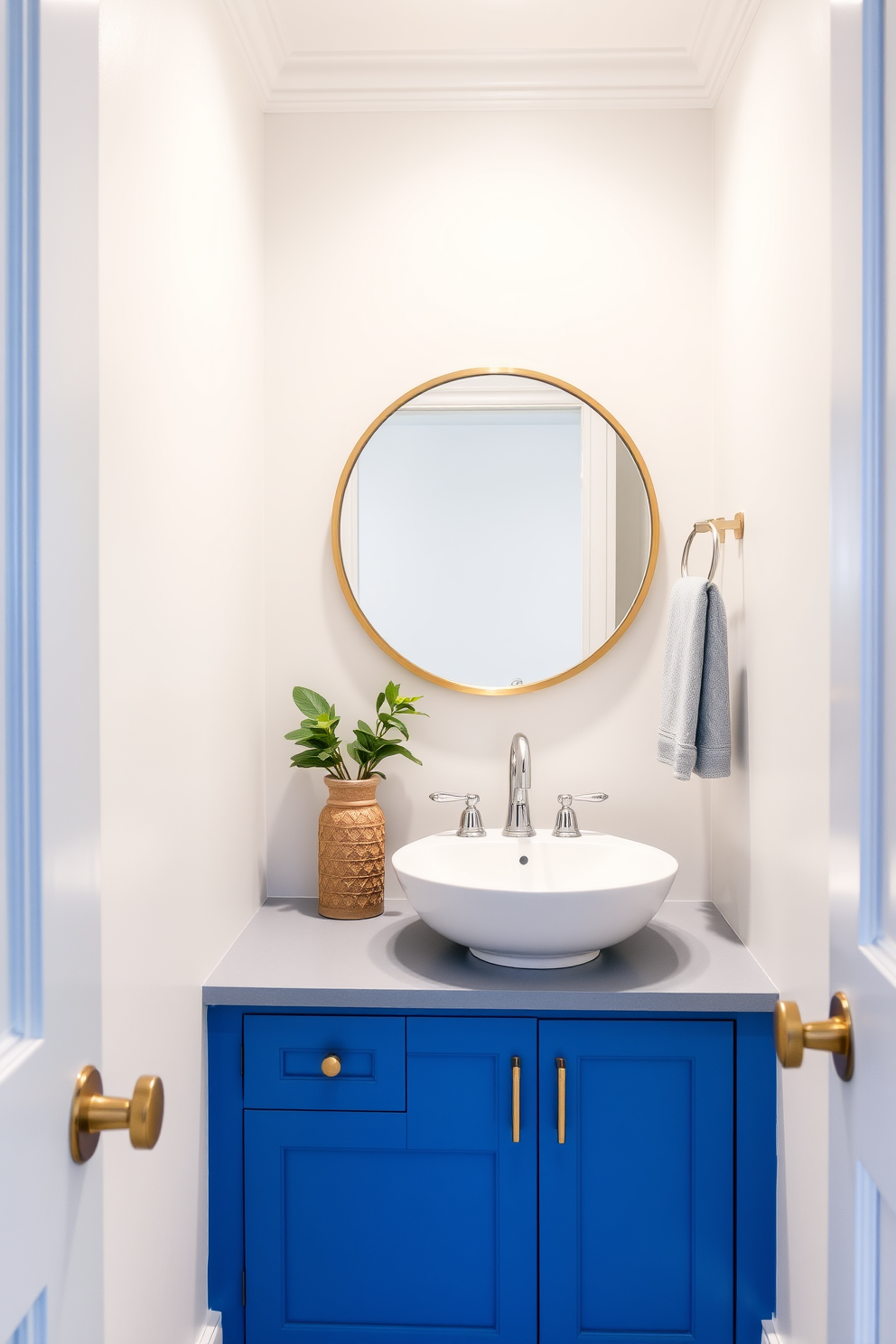 Cerulean blue cabinetry adds a fresh and vibrant touch to the powder room. The walls are painted in a soft white to create a bright and airy atmosphere, enhancing the beauty of the blue cabinetry. A stylish round mirror with a gold frame is mounted above a sleek white sink. Decorative accents like a small potted plant and elegant hand towels complement the overall design, adding warmth and personality to the space.