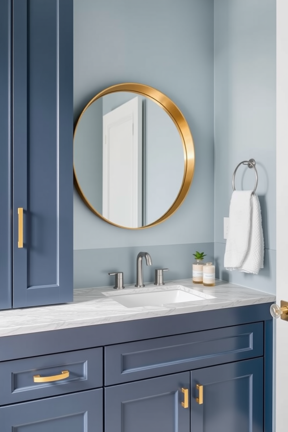 Sleek navy cabinetry with a polished marble countertop defines the elegance of this blue powder room. The cabinetry features minimalist handles and is complemented by a stylish undermount sink, creating a seamless look. The walls are adorned in a soft powder blue, enhancing the room's airy feel. A large round mirror with a brushed gold frame hangs above the sink, reflecting the sophisticated design elements throughout the space.