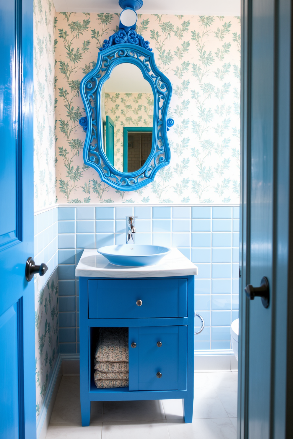 A vibrant powder room featuring bright blue fixtures that add a playful twist. The walls are adorned with a cheerful wallpaper pattern, and the floor is covered in light-colored tiles that enhance the room's brightness. A sleek blue vanity with a white countertop holds a stylish round sink. Above the vanity, a unique mirror with a blue frame reflects the lively atmosphere of the space.