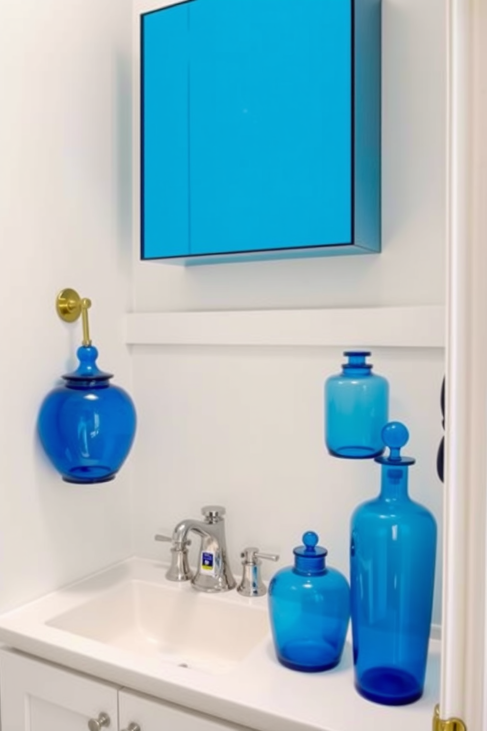 A chic powder room featuring blue glass accessories that add a stylish finish. The walls are painted in a soft white, creating a bright and airy atmosphere. A sleek vanity with a polished chrome faucet complements the blue glass elements. Decorative blue glass jars and vases are strategically placed throughout the room for a cohesive look.