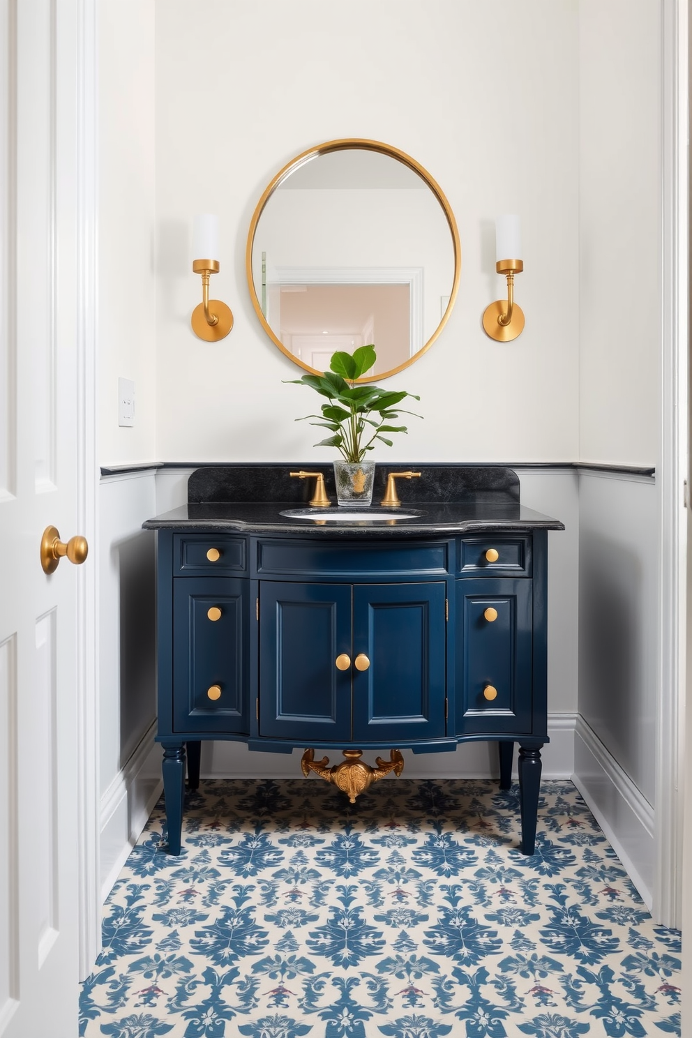 A deep blue vanity with brass fixtures stands out against the soft white walls of the powder room. The elegant design is complemented by a round mirror with a brass frame and stylish sconces on either side, casting a warm glow. The floor is adorned with intricate patterned tiles in shades of blue and white, adding a touch of sophistication. A small potted plant sits atop the vanity, bringing a refreshing element to the space.