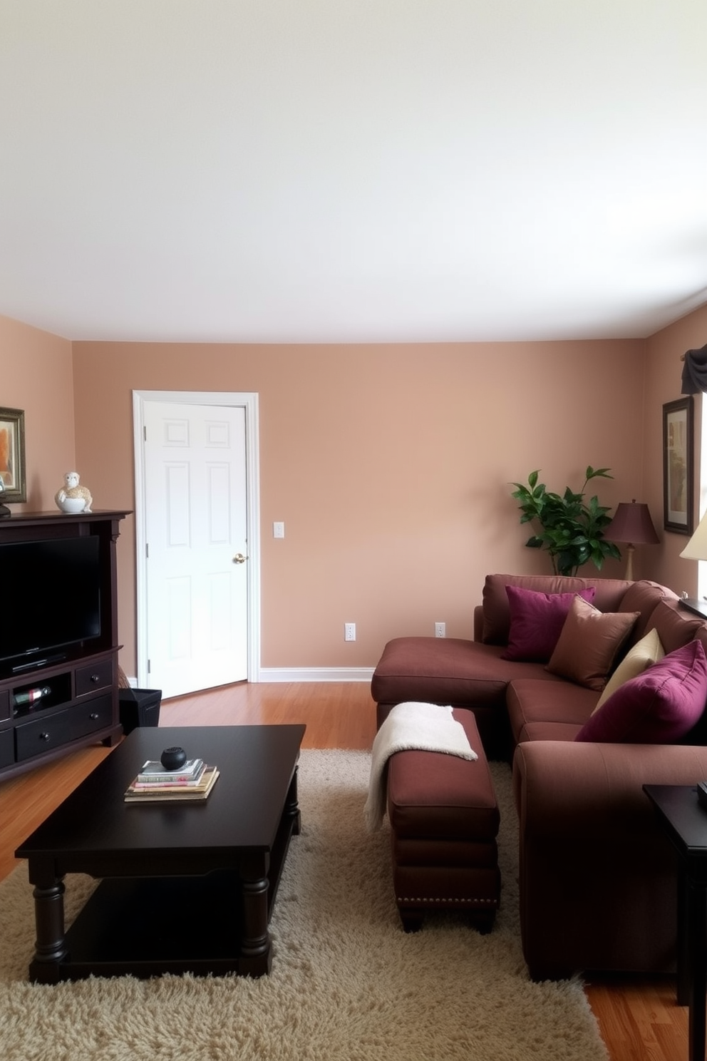 A cozy living room featuring light brown walls that create a warm and inviting atmosphere. The space is furnished with dark wood furniture, including a large coffee table and a comfortable sectional sofa. Accent pillows in rich, deep colors add a pop of contrast against the dark furniture. A plush area rug lies beneath the coffee table, tying the room together and enhancing the overall comfort of the space.