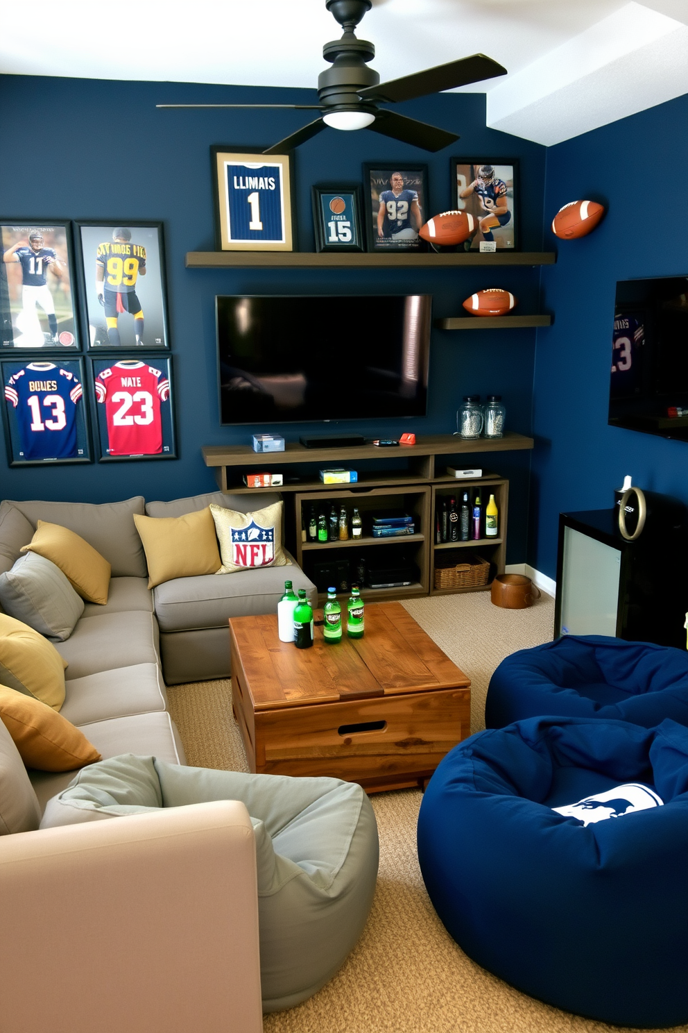 A cozy man cave featuring a comfortable sectional sofa with plush cushions and a large flat-screen TV mounted on the wall. Sports memorabilia decorates the space, including framed jerseys and signed footballs displayed on shelves. The walls are painted in a deep navy blue, creating a relaxed atmosphere. A rustic wooden coffee table sits in the center, surrounded by bean bags and a mini-fridge stocked with drinks for entertaining guests.