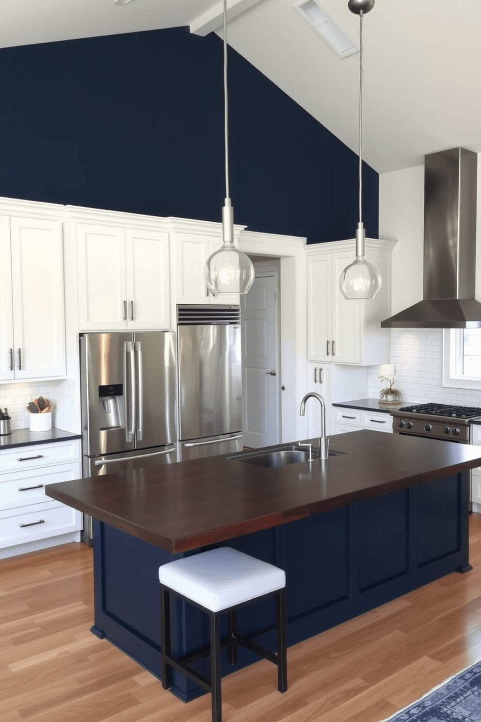 An accent wall painted in a bold navy blue creates a striking focal point in the kitchen. The surrounding walls are a soft white, enhancing the vibrancy of the accent color. The kitchen features sleek stainless steel appliances and a large island with a dark wood countertop. Pendant lights hang above the island, providing both illumination and style.