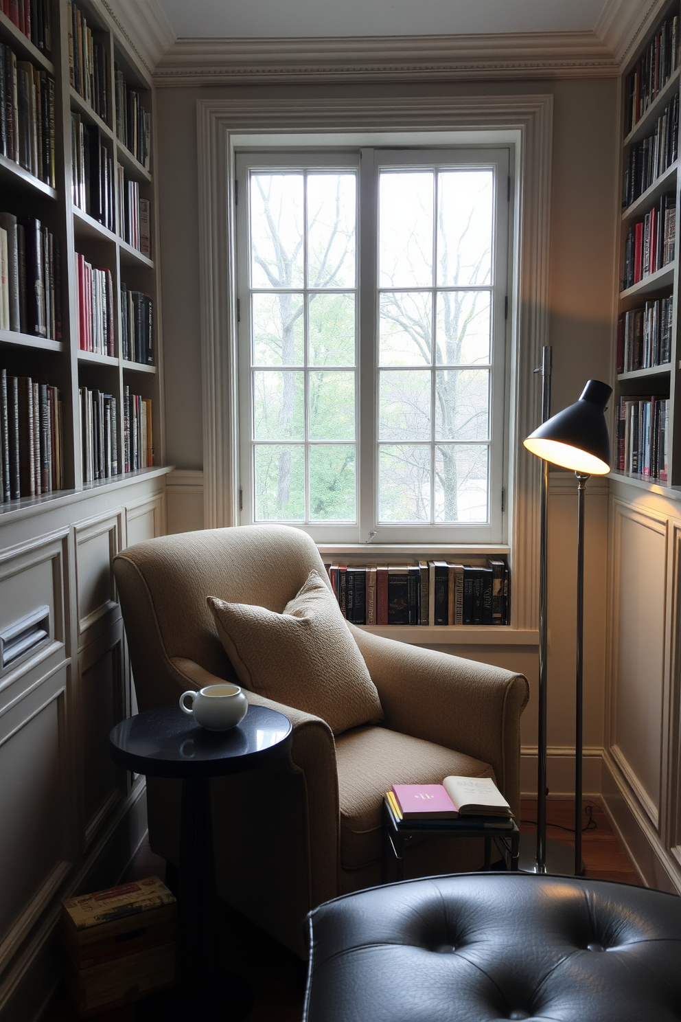 A cozy reading nook by the window features a plush armchair upholstered in soft fabric. A small side table holds a steaming cup of tea and a stack of well-loved books. The walls are lined with built-in bookshelves filled with a curated collection of literature. Warm lighting from a nearby floor lamp creates an inviting atmosphere for hours of reading.