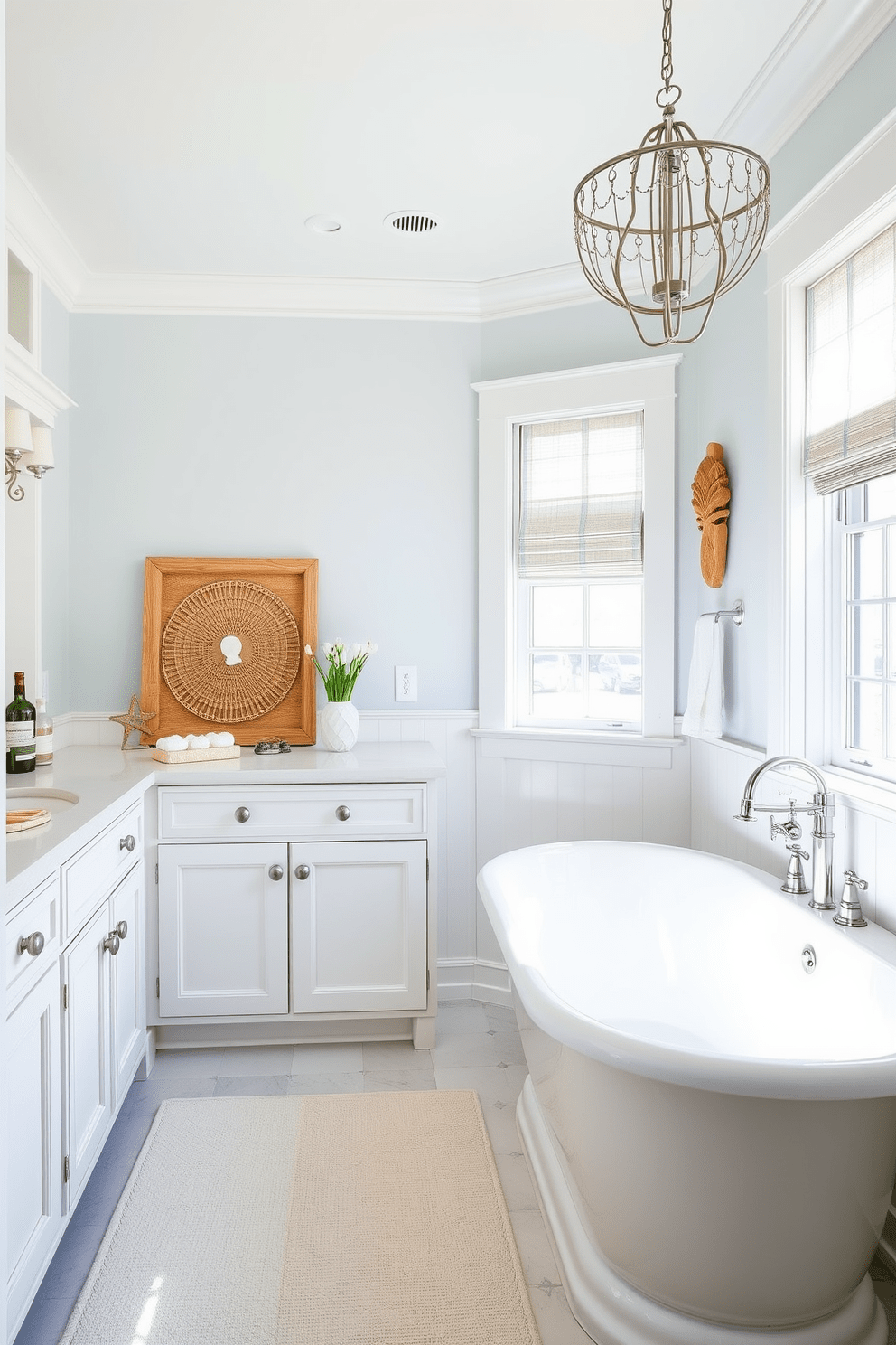 A bright and airy coastal bathroom features whitewashed cabinetry that enhances the fresh and clean aesthetic. The cabinetry is complemented by soft blue accents and natural wood elements, creating a serene atmosphere. The space is adorned with a large freestanding tub positioned near a window that allows natural light to flood in. Nautical-themed decor, such as seashells and driftwood, adds a charming touch to the overall design.