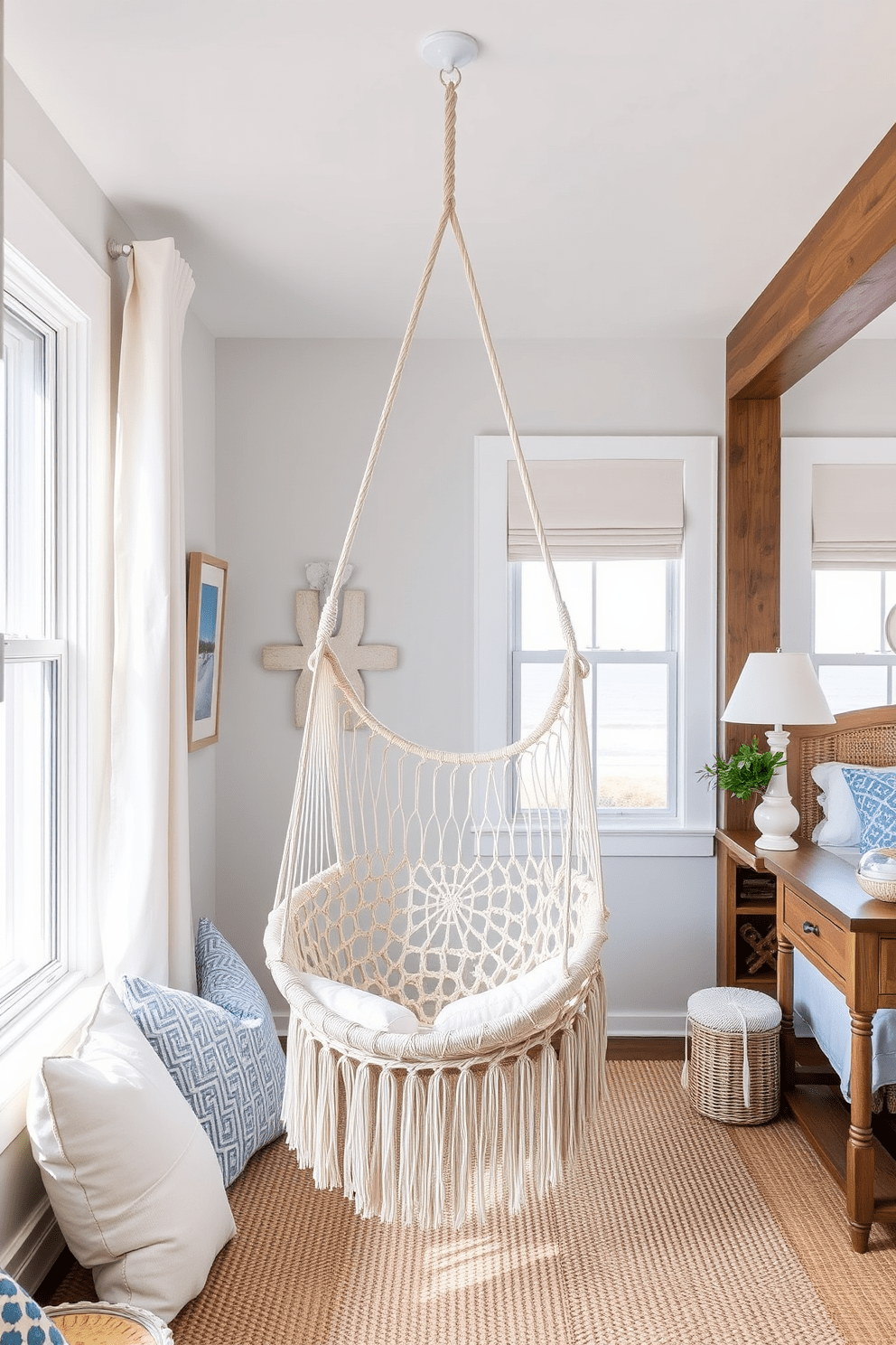 A cozy nook features a hammock chair suspended from the ceiling, inviting relaxation with its soft, woven texture. Surrounding the chair, light pastel colors create a serene atmosphere, complemented by natural wood accents. The coastal bedroom design incorporates light, airy fabrics and a color palette inspired by the ocean. Large windows allow natural light to flood the space, while nautical decor elements add a touch of seaside charm.