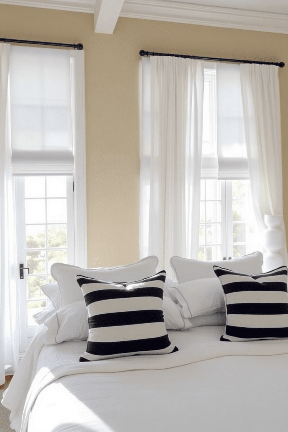 A serene coastal bedroom featuring nautical stripes on the bedding and curtains. The walls are painted in a soft sandy beige, complementing the light blue accents throughout the room. A comfortable bed is dressed in crisp white linens with navy and white striped pillows. Large windows allow natural light to flood the space, framed by flowing sheer curtains that echo the coastal theme.