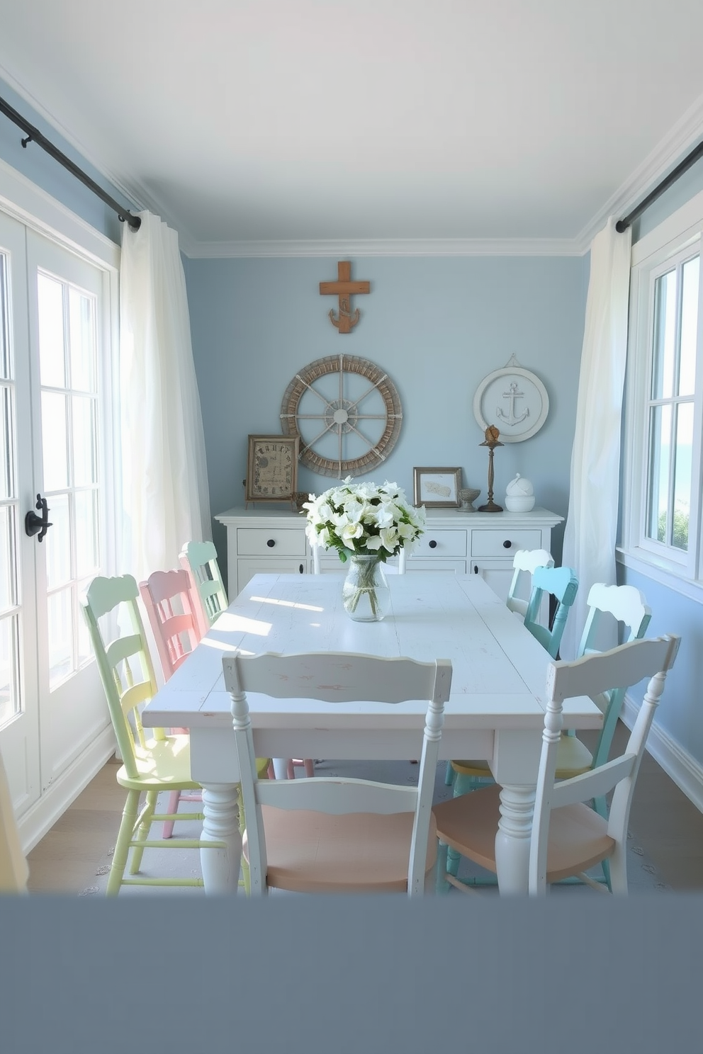 A coastal dining room features whitewashed wooden furniture that enhances the airy and relaxed atmosphere. The table is surrounded by mismatched chairs in soft pastel colors, creating a casual yet stylish vibe. Large windows allow natural light to flood the space, showcasing views of the ocean or greenery outside. Light, sheer curtains flutter gently in the breeze, adding to the serene coastal aesthetic. The walls are painted in a soft blue hue, reminiscent of the sea, while nautical-themed decor accents the room. A centerpiece of fresh flowers in a simple vase brings a touch of nature indoors, completing the breezy look.