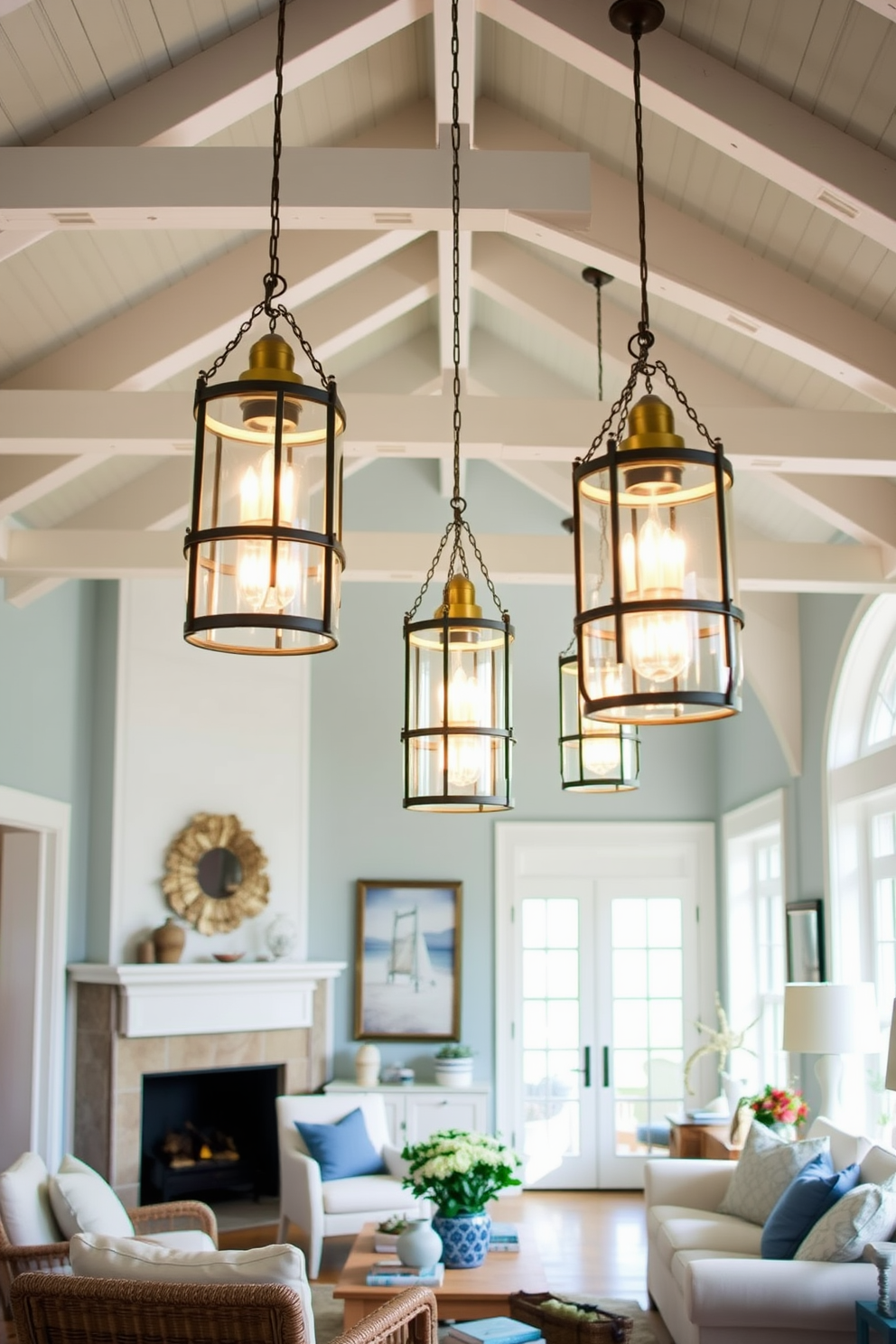 A coastal living room features glass lanterns suspended from the ceiling, casting a warm and inviting glow throughout the space. The walls are painted in soft blues and whites, complemented by natural wood accents and comfortable, airy furnishings.