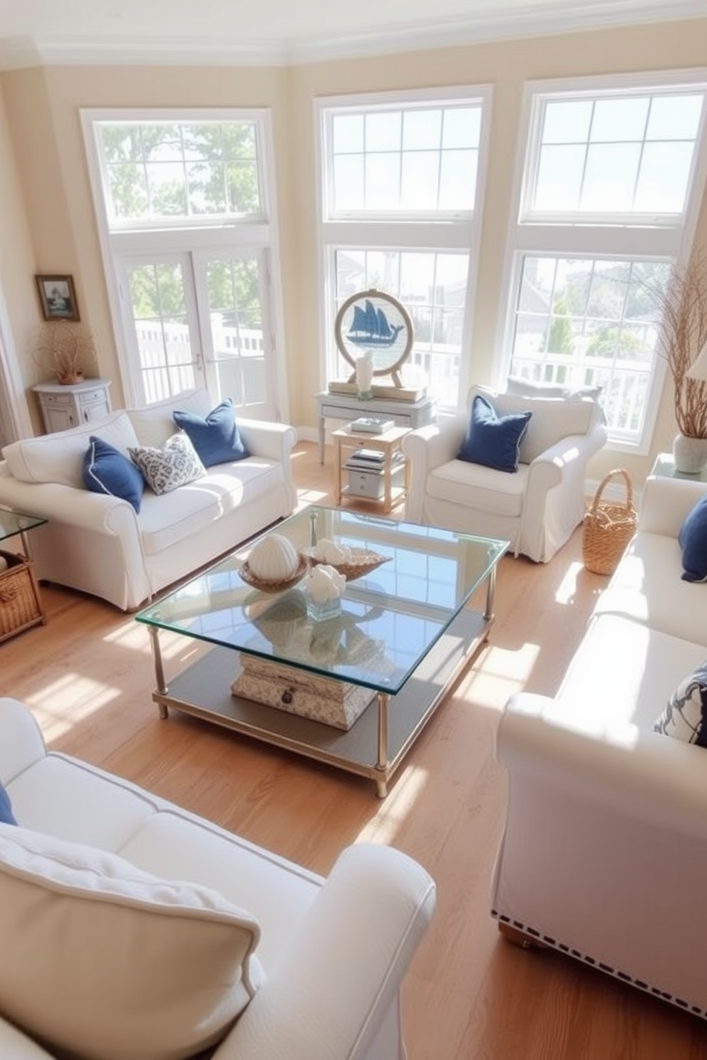 A bright and airy coastal living room features a glass coffee table that reflects the natural light streaming in through large windows. Surrounding the table are plush white sofas adorned with blue and beige throw pillows, creating a relaxed and inviting atmosphere. The walls are painted in a soft sandy beige, complementing the light wood flooring. Nautical decor elements, such as seashells and driftwood accents, are strategically placed throughout the room to enhance the coastal theme.