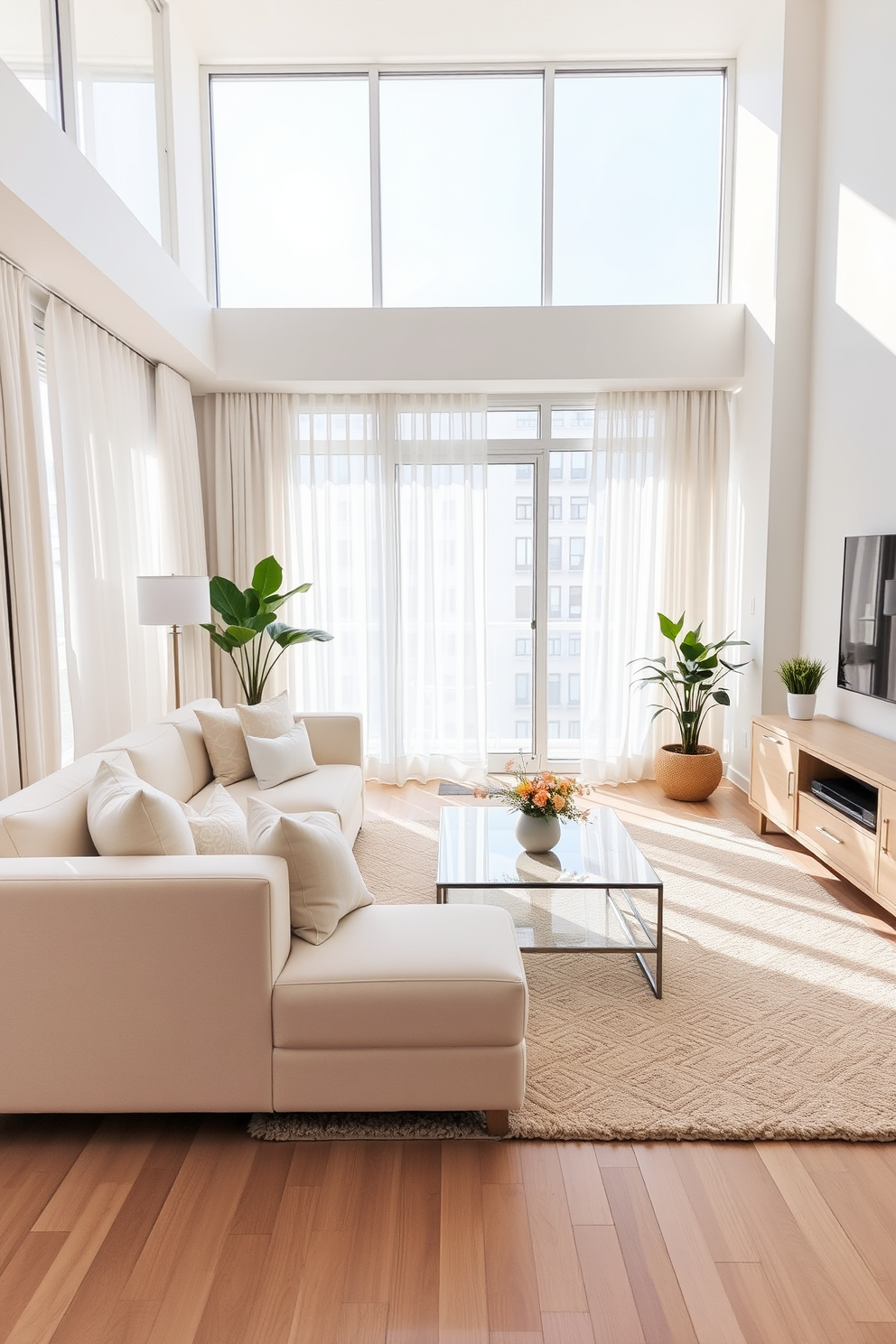 A bright and airy condo living room featuring light-colored furniture that enhances the sense of space. The room includes a plush white sofa adorned with pastel throw pillows, a glass coffee table, and a light wood media console. Large windows allow natural light to flood the room, complemented by sheer curtains that soften the sunlight. A cozy area rug in soft beige anchors the seating area, while a few indoor plants add a touch of greenery.