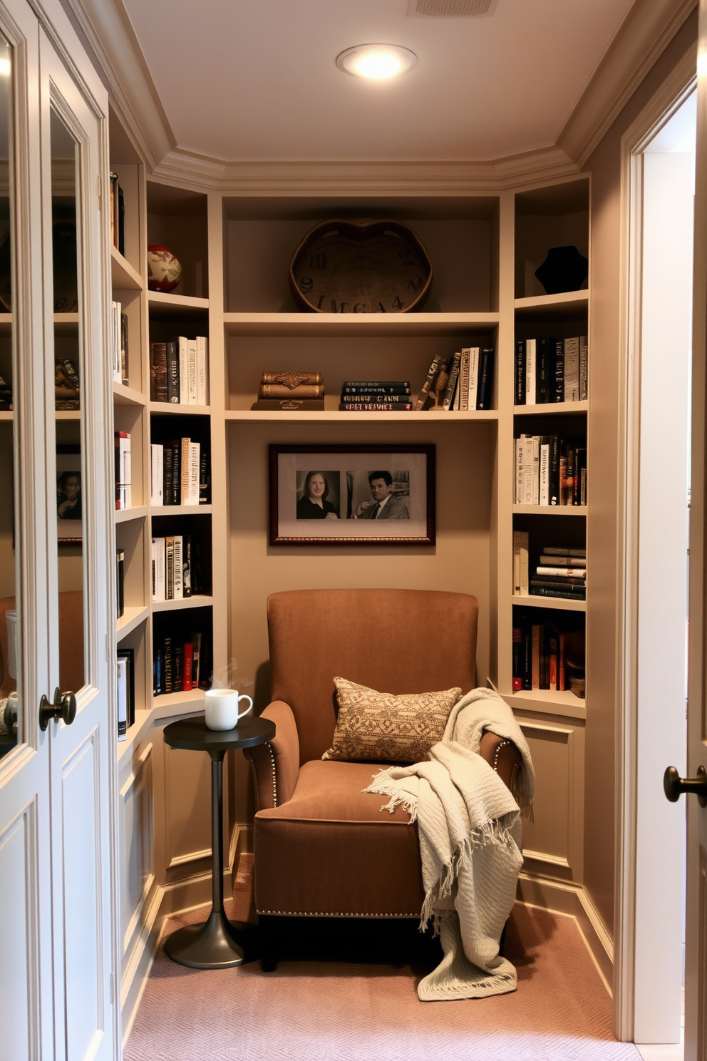 A cozy reading nook is nestled within a spacious walk-in closet. Soft lighting illuminates a plush armchair, surrounded by built-in shelves filled with books and decorative items. The walls are painted in a warm beige tone, creating a welcoming atmosphere. A small side table holds a steaming cup of tea, while a soft throw blanket drapes over the armchair for added comfort.