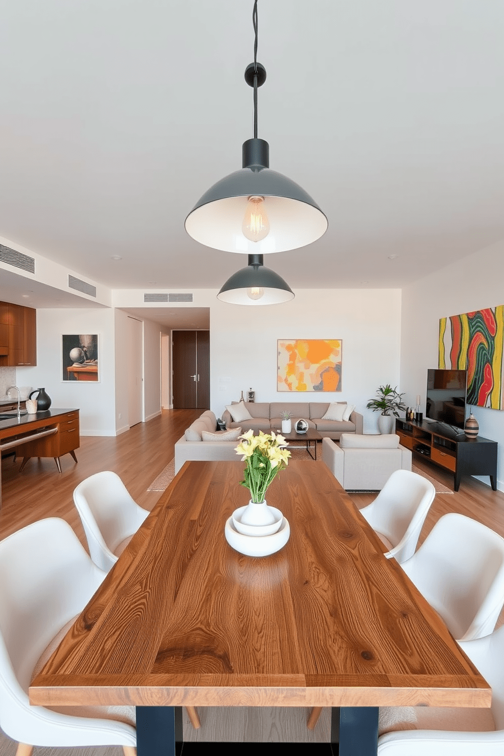 A contemporary apartment features stylish pendant lights hanging over a sleek dining table made of reclaimed wood. The open-concept living space is adorned with modern furniture in neutral tones, accented by vibrant artwork on the walls.