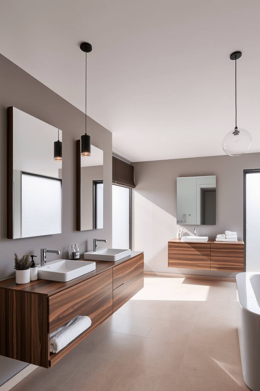 Sleek floating vanities with integrated sinks create a modern and minimalist aesthetic in the bathroom. The vanities are finished in a rich walnut wood, complementing the clean lines of the space. Large rectangular mirrors are mounted above the vanities, reflecting the natural light that floods in through frosted glass windows. The walls are painted in a soft gray, enhancing the contemporary feel of the design. Stylish pendant lights hang from the ceiling, providing ambient illumination while adding a touch of elegance. The flooring features large-format porcelain tiles in a light beige, creating a seamless look throughout the room. A few carefully chosen decorative elements, such as a potted plant and designer soap dispensers, add personality without overwhelming the space. Soft, plush towels are neatly arranged on a floating shelf, inviting comfort and luxury.