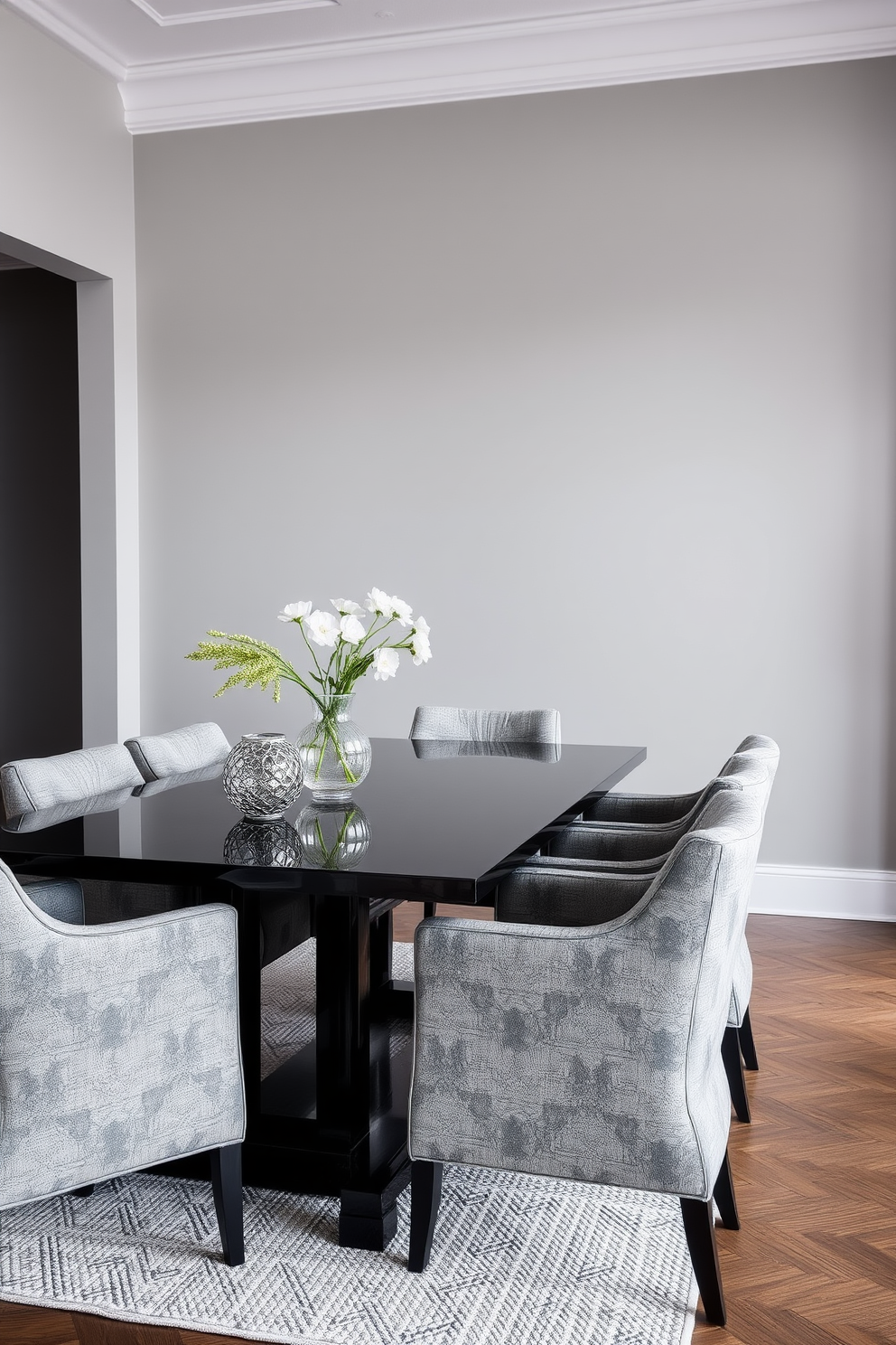 A contemporary dining room featuring a monochromatic color scheme with varying textures. The walls are painted in a soft gray, while the dining table is a sleek black with a glossy finish. Around the table, upholstered chairs in a matching gray fabric provide comfort and style. A textured area rug in a lighter shade anchors the space, adding warmth and depth.