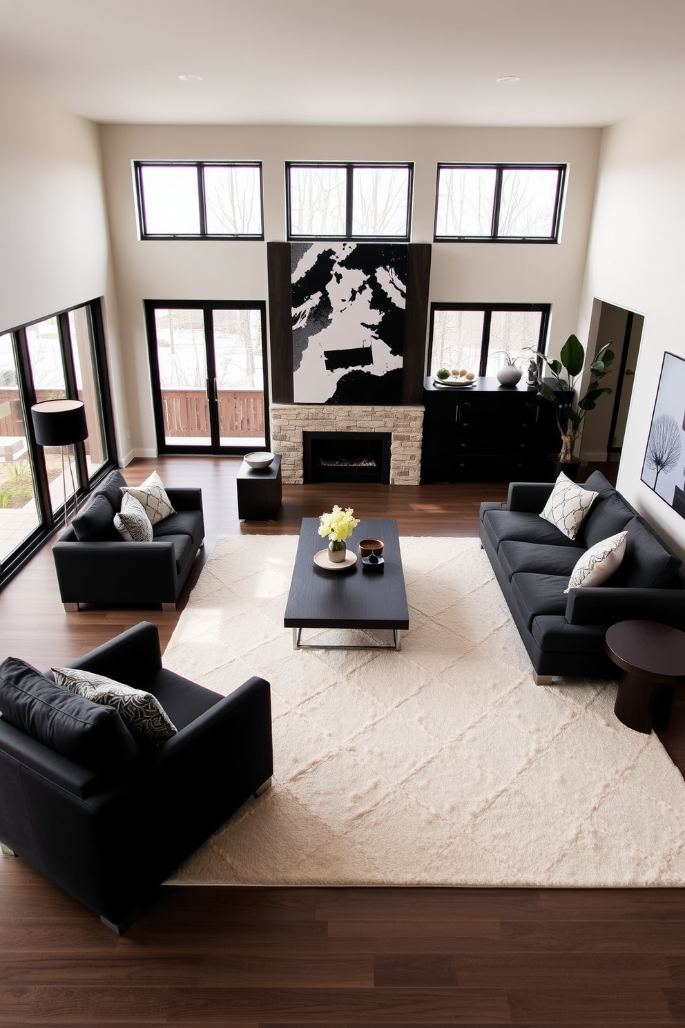 A contemporary family room featuring a striking contrast between light and dark tones. The walls are painted a soft beige while the furniture includes a deep charcoal sectional sofa that invites relaxation. A large area rug in a light cream color anchors the space, contrasting beautifully with the dark wood coffee table at the center. Floor-to-ceiling windows allow natural light to flood the room, highlighting the sleek lines of the modern decor.