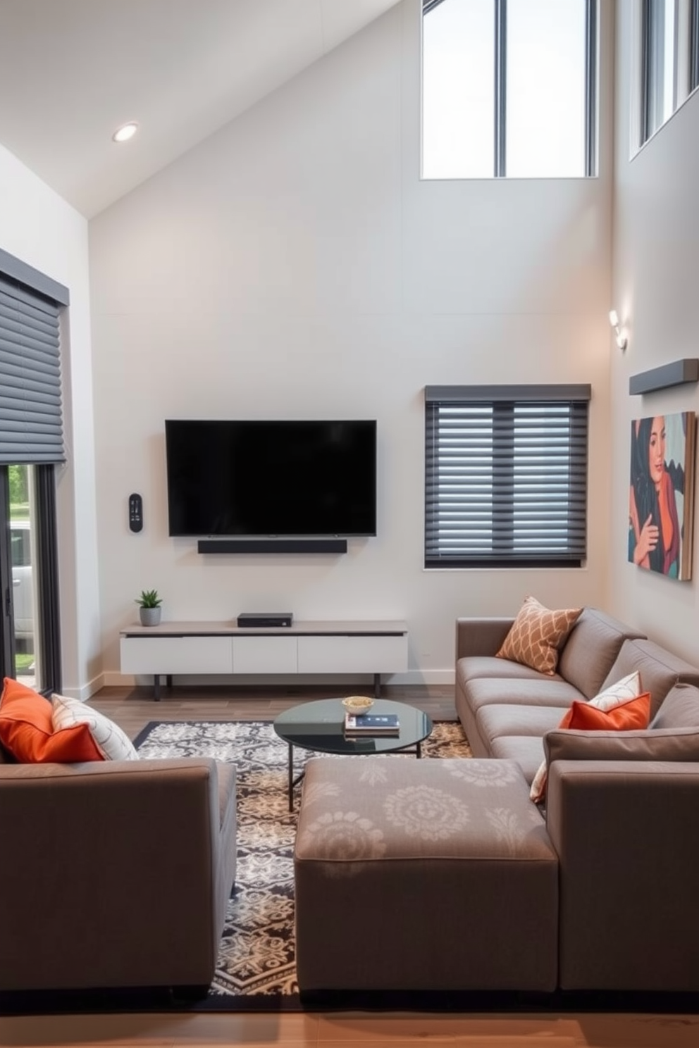 A contemporary family room featuring integrated technology for modern living. The space includes a sleek sectional sofa facing a wall-mounted flat-screen TV, with smart home controls conveniently placed nearby. Large windows allow natural light to flood the room, complemented by automated blinds for privacy. The color palette consists of soft grays and warm whites, accented by vibrant artwork and a stylish area rug.