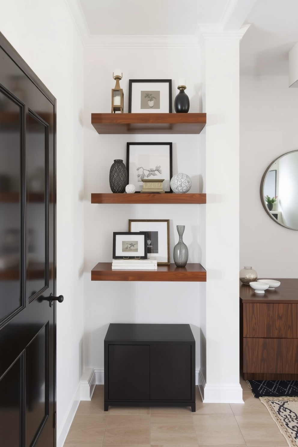 A contemporary foyer features floating shelves that display a curated selection of decor items, creating an inviting and stylish entrance. The walls are painted in a soft neutral tone, enhancing the modern aesthetic while allowing the decor to stand out.