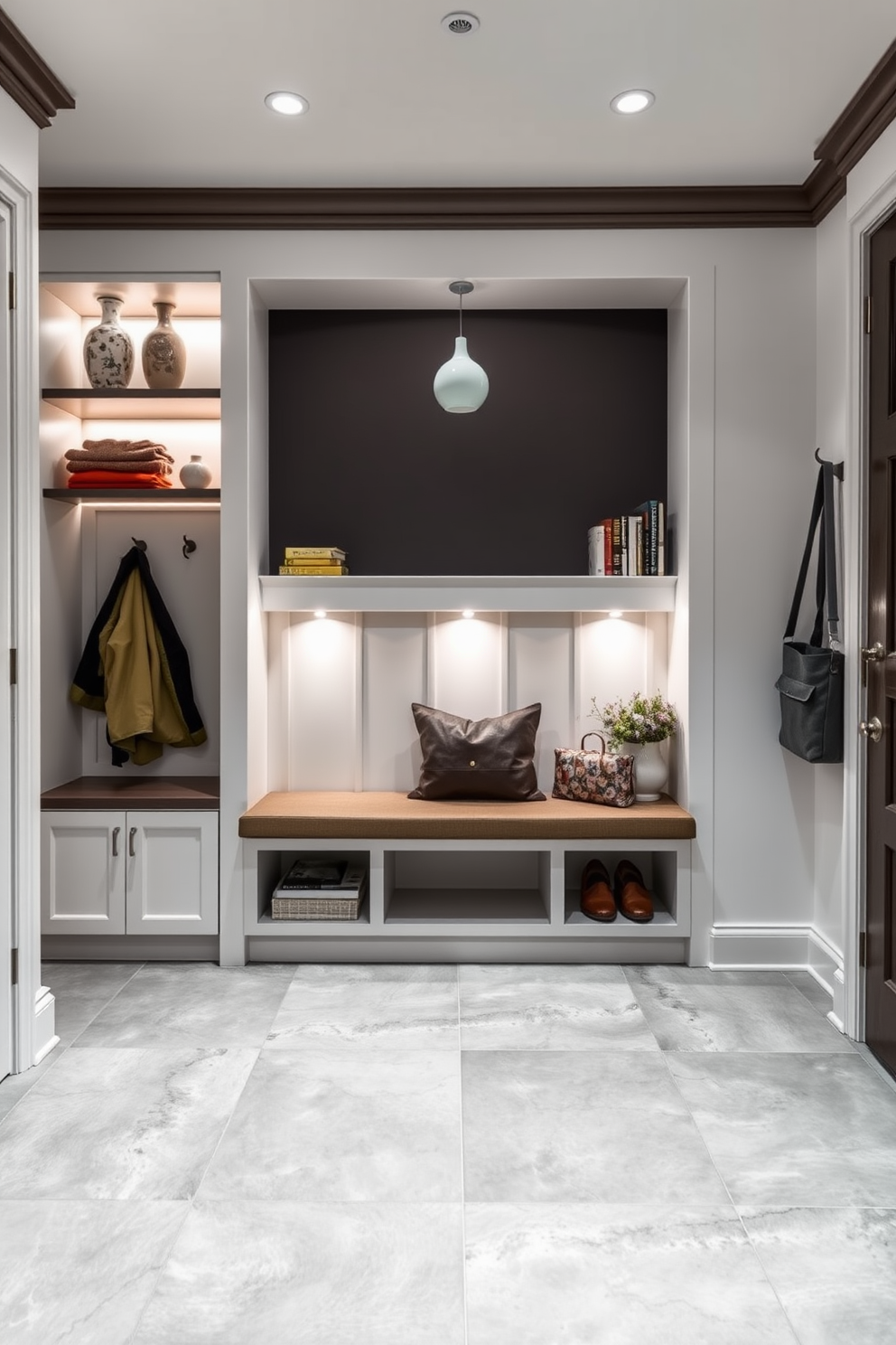 A modern mudroom featuring a lighted display for decorative items. The space includes built-in shelving illuminated by soft LED lights, showcasing a curated selection of vases and books. The flooring is a durable tile in a neutral gray tone, while the walls are painted a crisp white for a fresh look. A bench with storage underneath provides a practical yet stylish seating area, complemented by hooks for coats and bags.