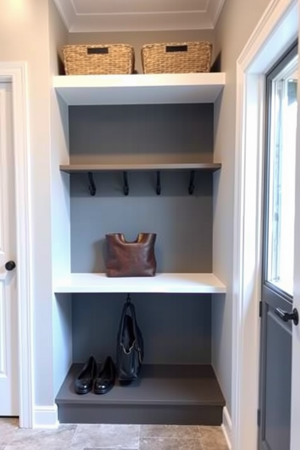 A contemporary mudroom features a stylish hooks and shelves combo for versatility. The walls are painted in a light gray tone, and the floor is adorned with durable ceramic tiles in a neutral shade.