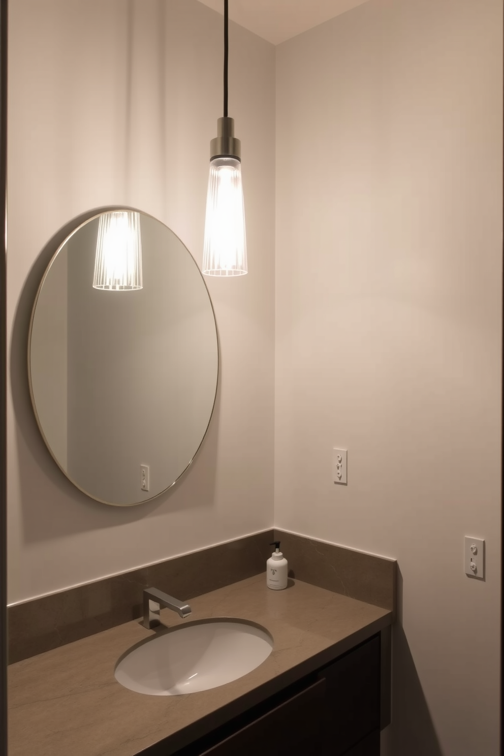 A contemporary powder room featuring a stylish statement lighting fixture suspended above the sink. The space is adorned with sleek finishes and a minimalist aesthetic, creating a chic and inviting atmosphere.