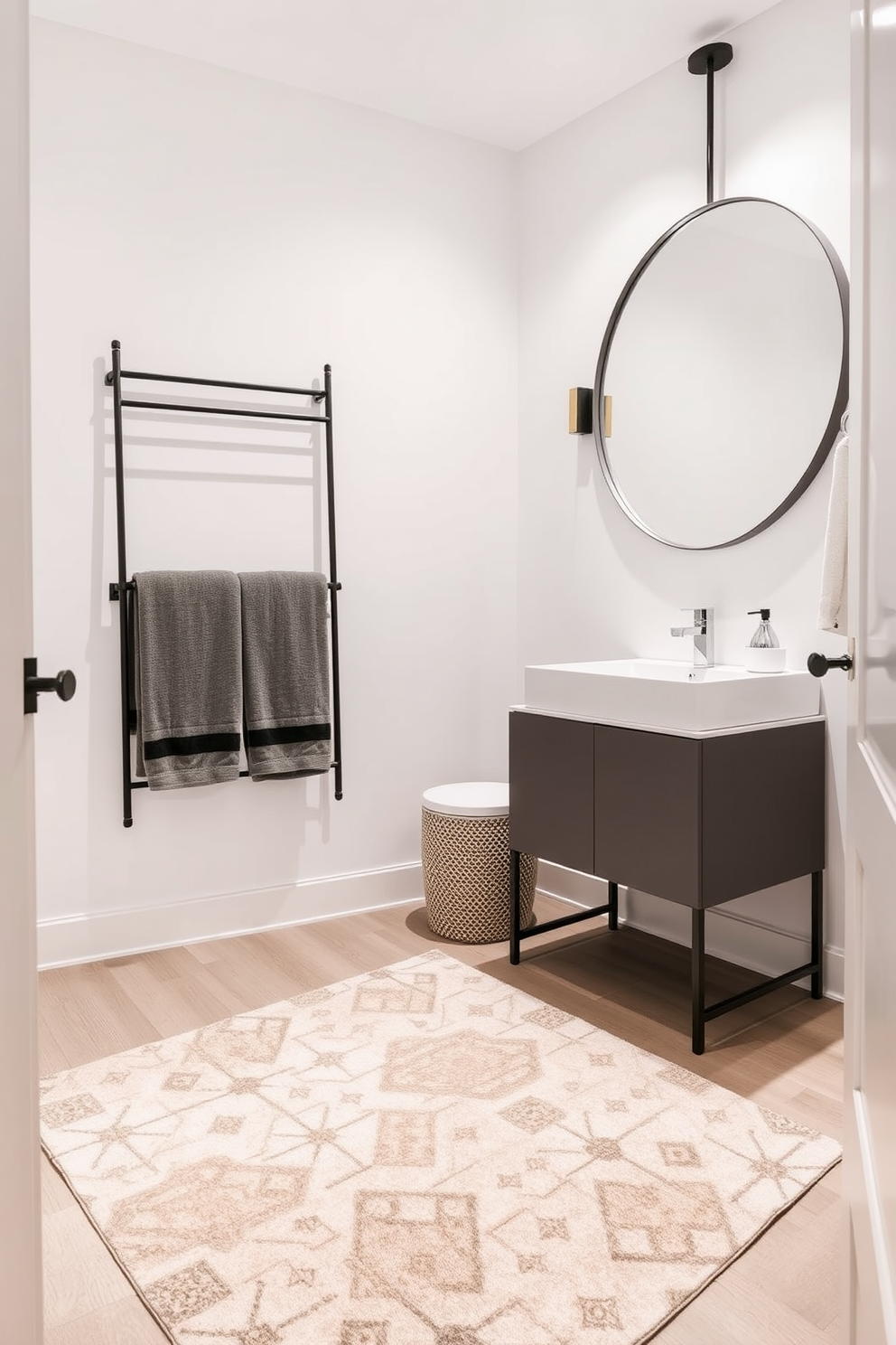 A stylish rug in a contemporary powder room adds warmth and texture to the space. The rug features a geometric pattern in soft neutral tones that complement the modern fixtures and decor. The powder room is designed with sleek lines and minimalist aesthetics. A wall-mounted sink and a large round mirror create an open and inviting atmosphere.