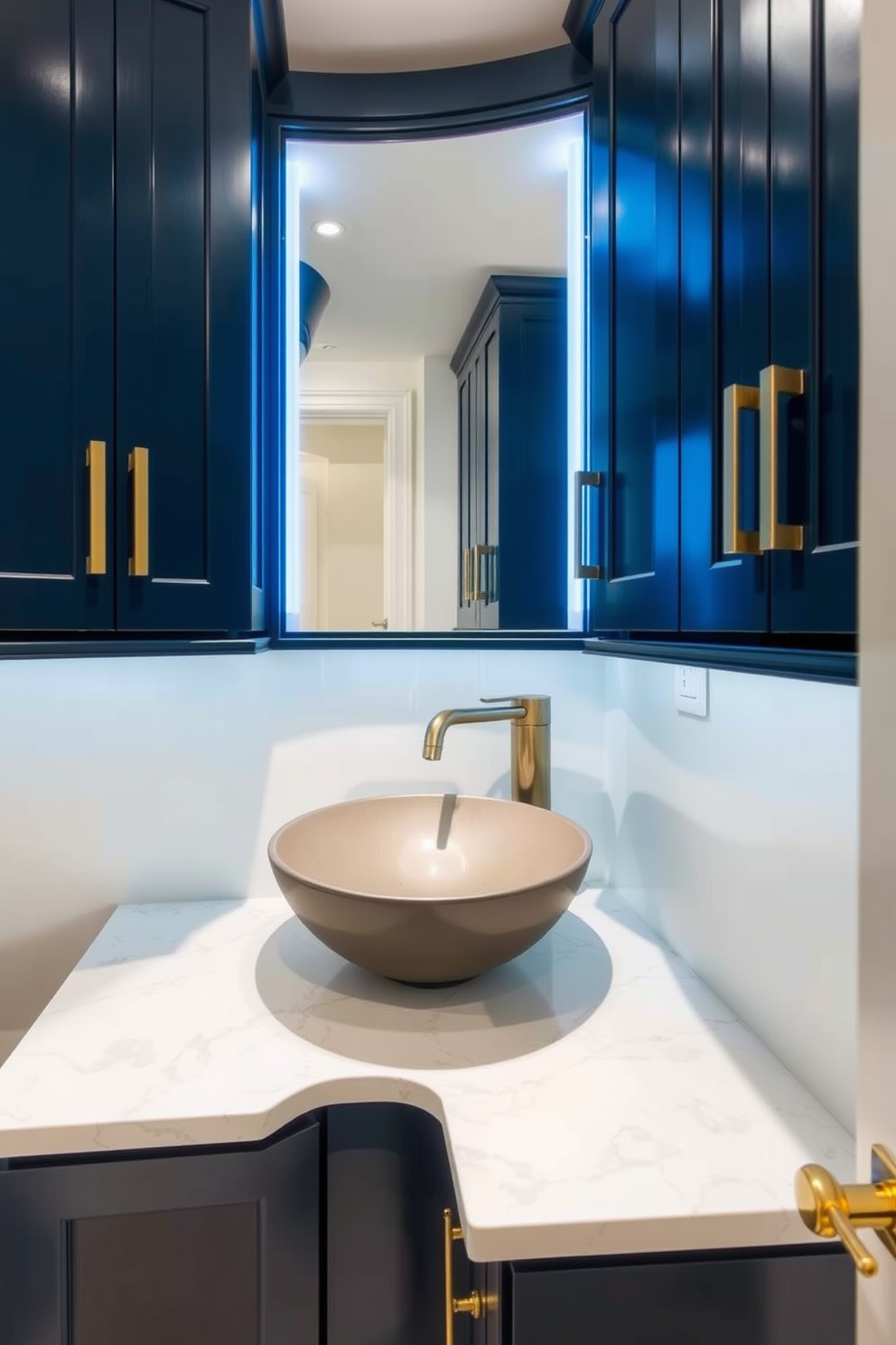 A contemporary powder room features cabinetry with integrated lighting that highlights the sleek design and enhances functionality. The cabinetry is finished in a rich navy blue, complemented by brushed gold hardware and a stylish vessel sink on a white marble countertop.