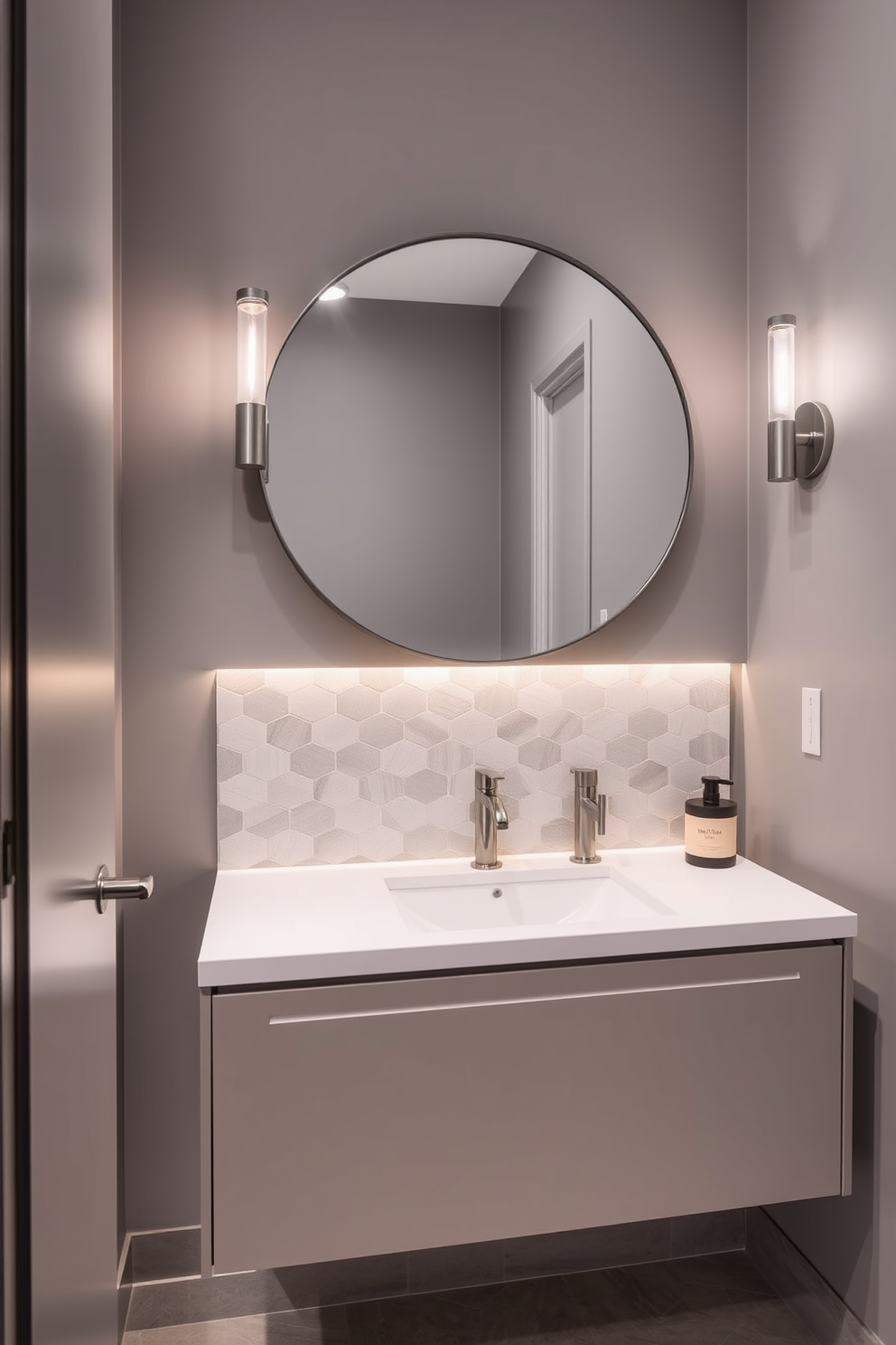 A sleek powder room features a minimalist design with a floating vanity and a large round mirror above it. The walls are painted in a soft gray, complemented by elegant lighting fixtures that enhance the modern finishes. The faucet designs are streamlined and polished, showcasing a blend of chrome and matte black finishes. A stylish backsplash made of geometric tiles adds a touch of sophistication to the overall contemporary aesthetic.