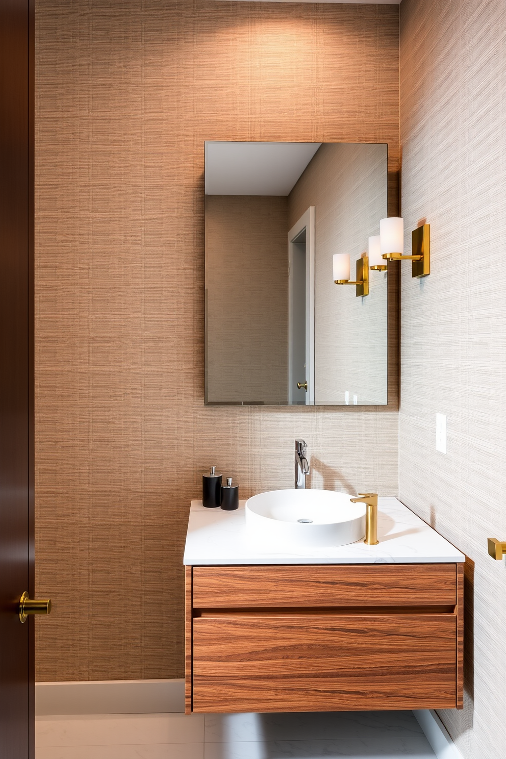 A contemporary powder room featuring sleek high-end finishes. The walls are adorned with textured wallpaper in a soft taupe, complemented by elegant brass fixtures. A floating vanity made of rich walnut wood showcases a stunning quartz countertop with an integrated sink. Above the vanity, a large backlit mirror enhances the space, while stylish sconces provide warm ambient lighting.