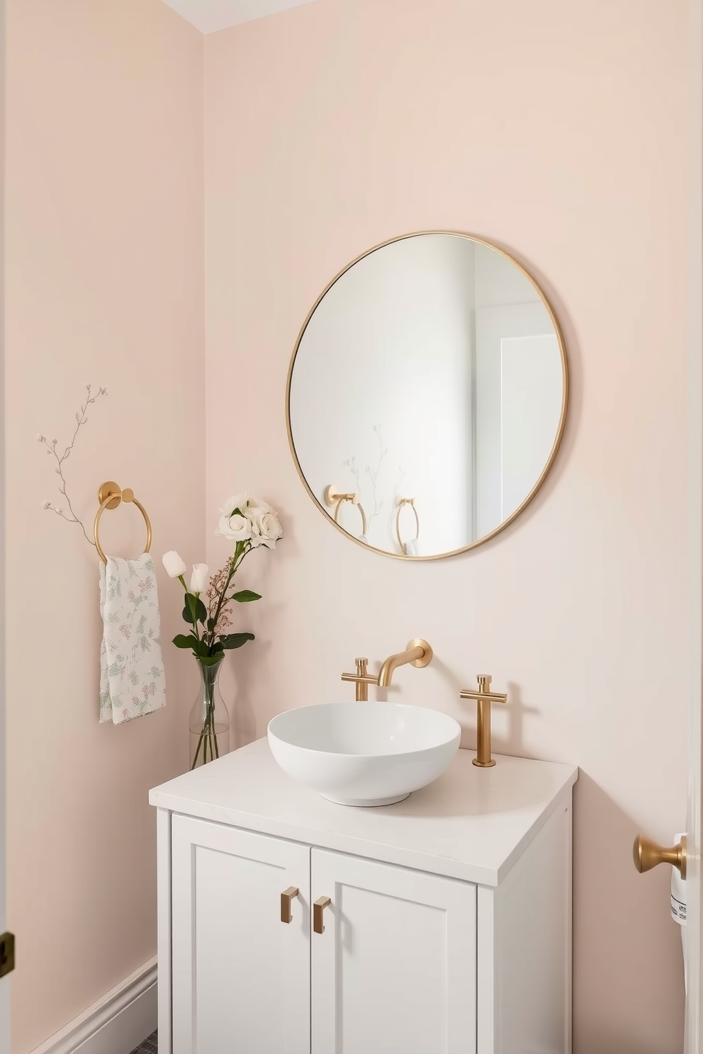 A serene powder room featuring soft pastel hues on the walls that create a calming atmosphere. The space includes a sleek white vanity with a round vessel sink and elegant brushed gold fixtures. Delicate floral wallpaper adds a touch of charm while complementing the overall soft color palette. A large round mirror with a thin gold frame hangs above the vanity, enhancing the room's brightness and spaciousness.