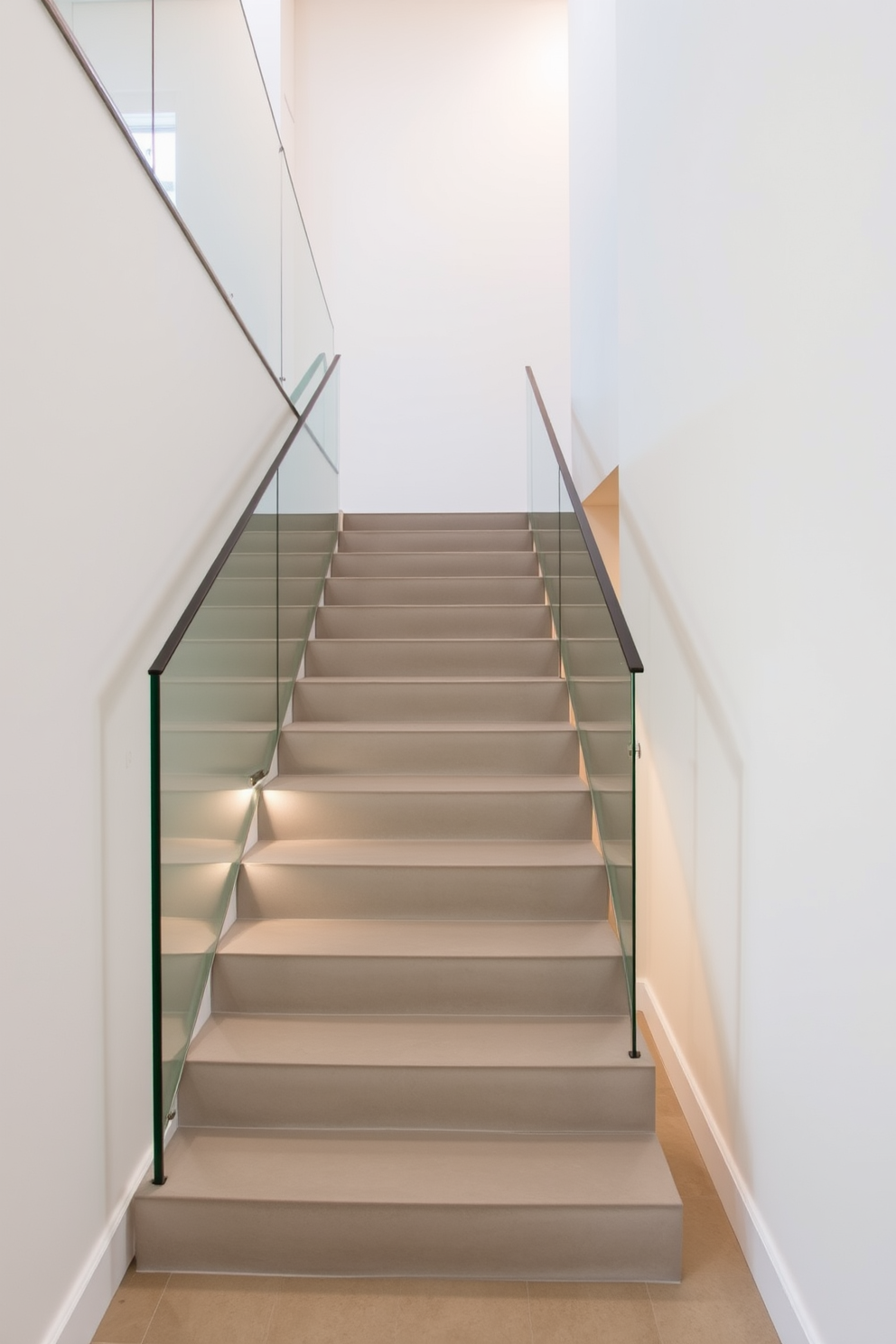 A sleek staircase features polished concrete steps that seamlessly connect different levels of the home. The minimalist design is complemented by a glass railing that provides an unobstructed view and enhances the modern aesthetic. The surrounding walls are adorned with neutral tones, creating a clean and airy atmosphere. Soft lighting highlights the staircase, adding warmth and elegance to the contemporary design.