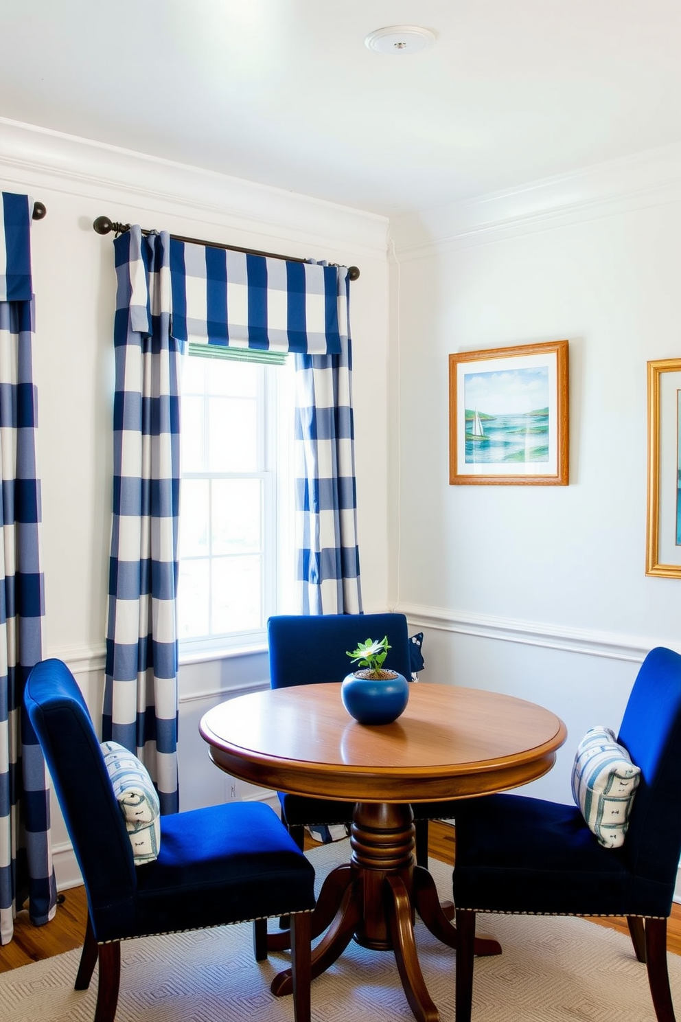 A cozy corner dining room featuring a nautical theme with blue accents. The walls are painted in a soft white, complemented by blue and white striped curtains that frame the windows. A round wooden table sits at the center, surrounded by comfortable upholstered chairs in navy blue. Nautical decor elements like a ship wheel and framed ocean artwork adorn the walls, creating a serene seaside atmosphere.