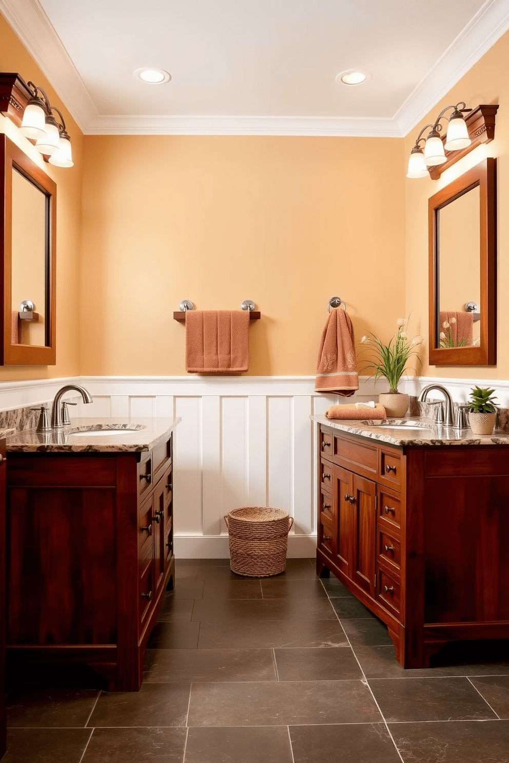 A spacious Craftsman bathroom featuring dual vanities crafted from rich mahogany wood. Each vanity is topped with a polished granite countertop and equipped with modern fixtures in brushed nickel. The walls are adorned with warm beige paint, complemented by white wainscoting that adds a classic touch. The floor is laid with large slate tiles, providing both durability and style. Above each vanity, there are framed mirrors with intricate wood detailing that reflect the natural light. Decorative elements include potted plants and plush towels in earthy tones, enhancing the cozy and inviting atmosphere.