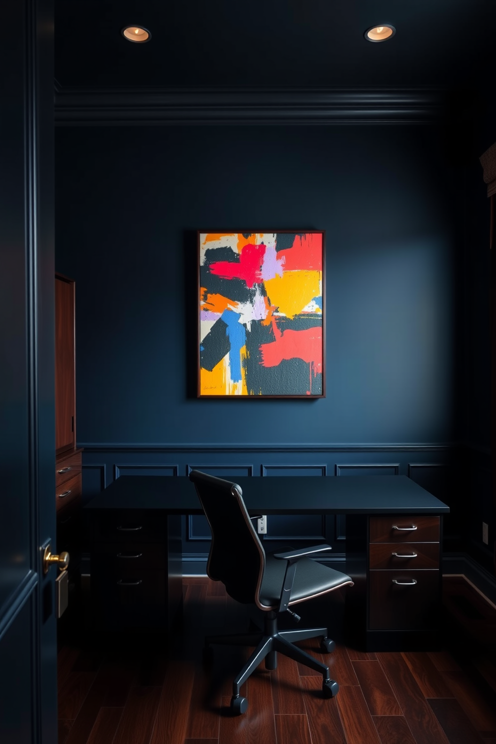 A dark study room featuring deep navy blue walls and rich mahogany furniture. A large abstract artwork with bold colors hangs prominently on the wall, providing a striking contrast to the room's moody palette. The study includes a sleek black desk paired with a modern ergonomic chair. Soft, warm lighting illuminates the space, highlighting the vibrant hues of the artwork and creating a cozy atmosphere.