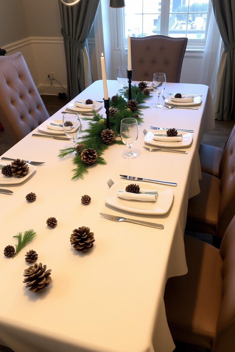 A beautifully set dining table adorned with natural pinecones scattered artfully across the surface. The table is elegantly dressed with a crisp white tablecloth and surrounded by plush upholstered chairs, creating a warm and inviting atmosphere for holiday gatherings.