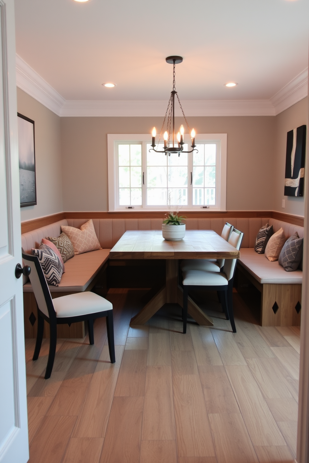 A cozy dining room features built-in bench seating along one wall, maximizing space while providing comfort. The bench is upholstered in a soft fabric, complemented by a large dining table made of reclaimed wood, surrounded by stylish chairs.