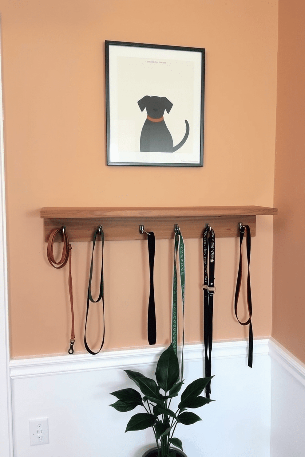 A stylish wall-mounted leash and collar organizer is designed to blend seamlessly with the decor of a modern dog lover's apartment. The organizer features a sleek wooden shelf with hooks for leashes and collars, complemented by a decorative dog-themed artwork above it. The walls are painted in a warm neutral tone, creating a cozy atmosphere. Below the organizer, a small potted plant adds a touch of greenery, enhancing the overall aesthetic of the space.