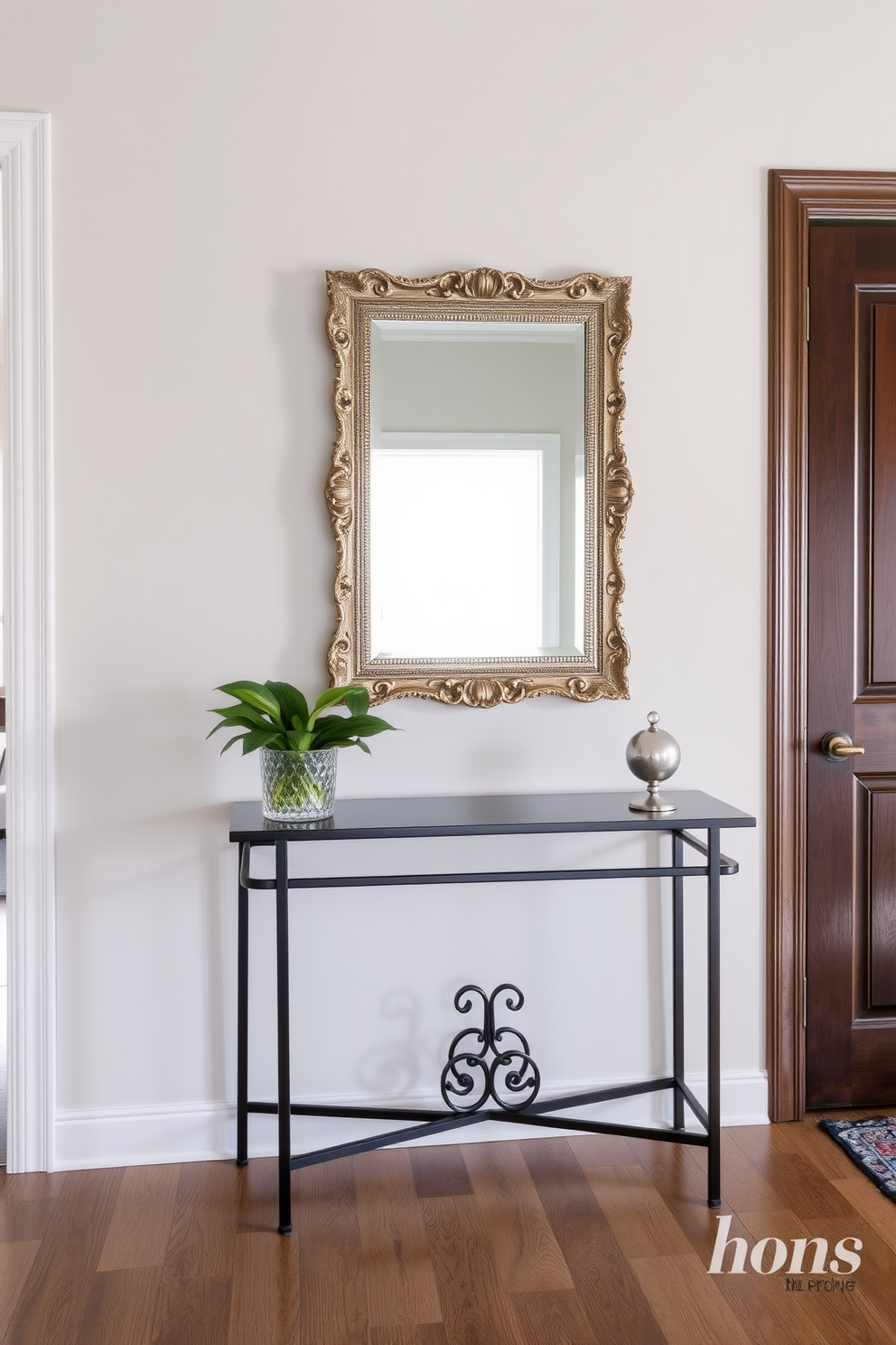 A stylish console table is positioned against the wall in the entrance foyer. Above the table, a decorative mirror with an ornate frame reflects the ambient light in the space.