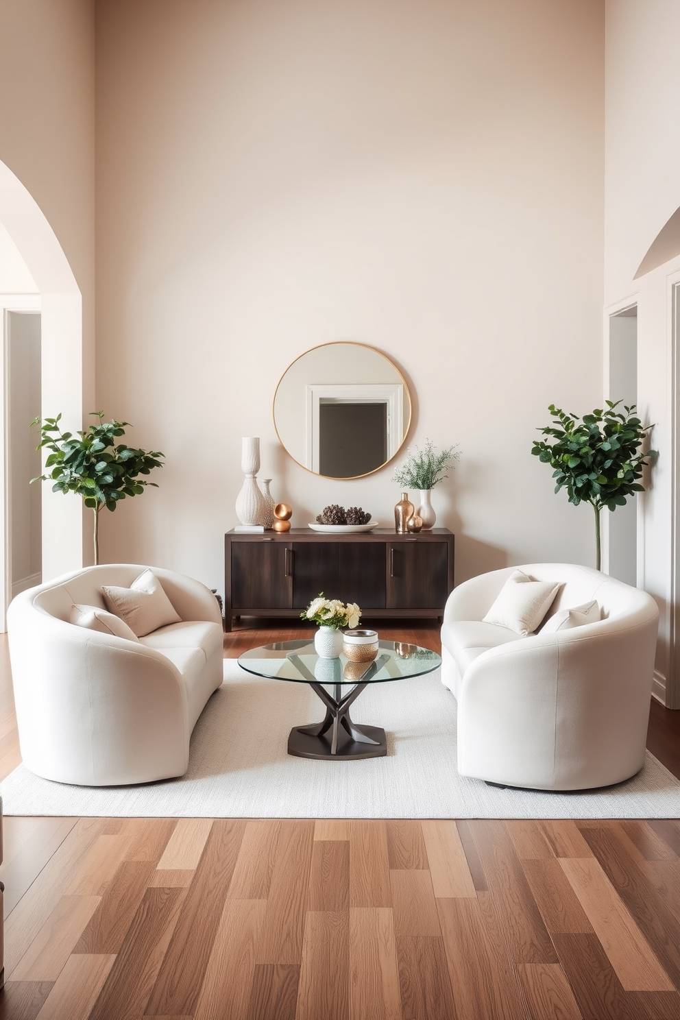 A welcoming entrance foyer features curved furniture that creates a soft and inviting atmosphere. The focal point is a plush curved sofa upholstered in a light fabric, complemented by a round coffee table with an elegant glass top. Flanking the sofa are two sculptural side chairs with gentle curves, adding a touch of sophistication. The walls are adorned with soft pastel colors, and a large circular mirror hangs above a console table, enhancing the sense of space.