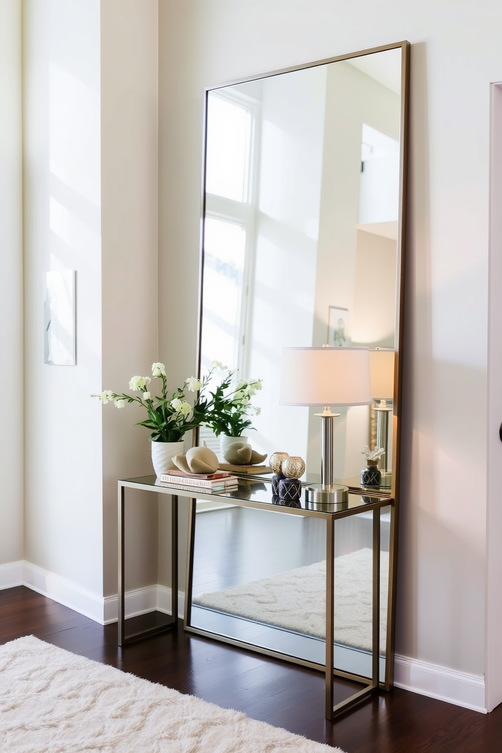 A large floor mirror leans against the wall in the entrance foyer, reflecting natural light and creating an illusion of a more spacious area. The foyer features a sleek console table adorned with decorative items and a stylish lamp, complemented by a soft area rug that adds warmth to the space.