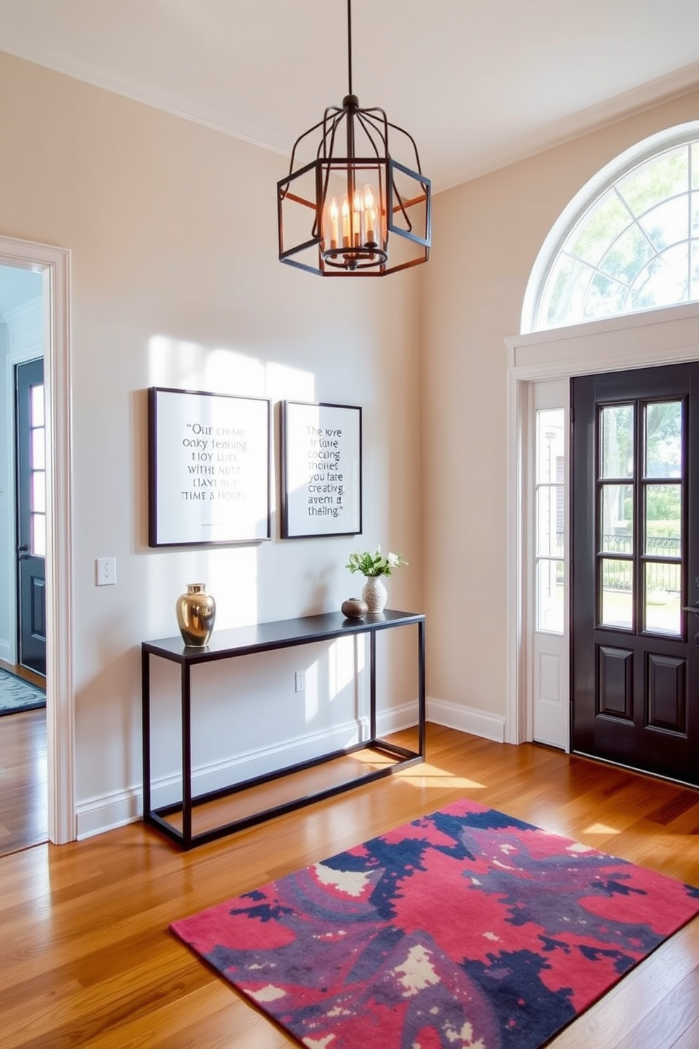 A welcoming entrance foyer filled with natural light. The space features a sleek console table against the wall adorned with framed quotes that inspire positivity and creativity. Elegant pendant lighting hangs above, casting a warm glow. The floor is finished with polished hardwood, and a vibrant area rug adds a touch of color underfoot.