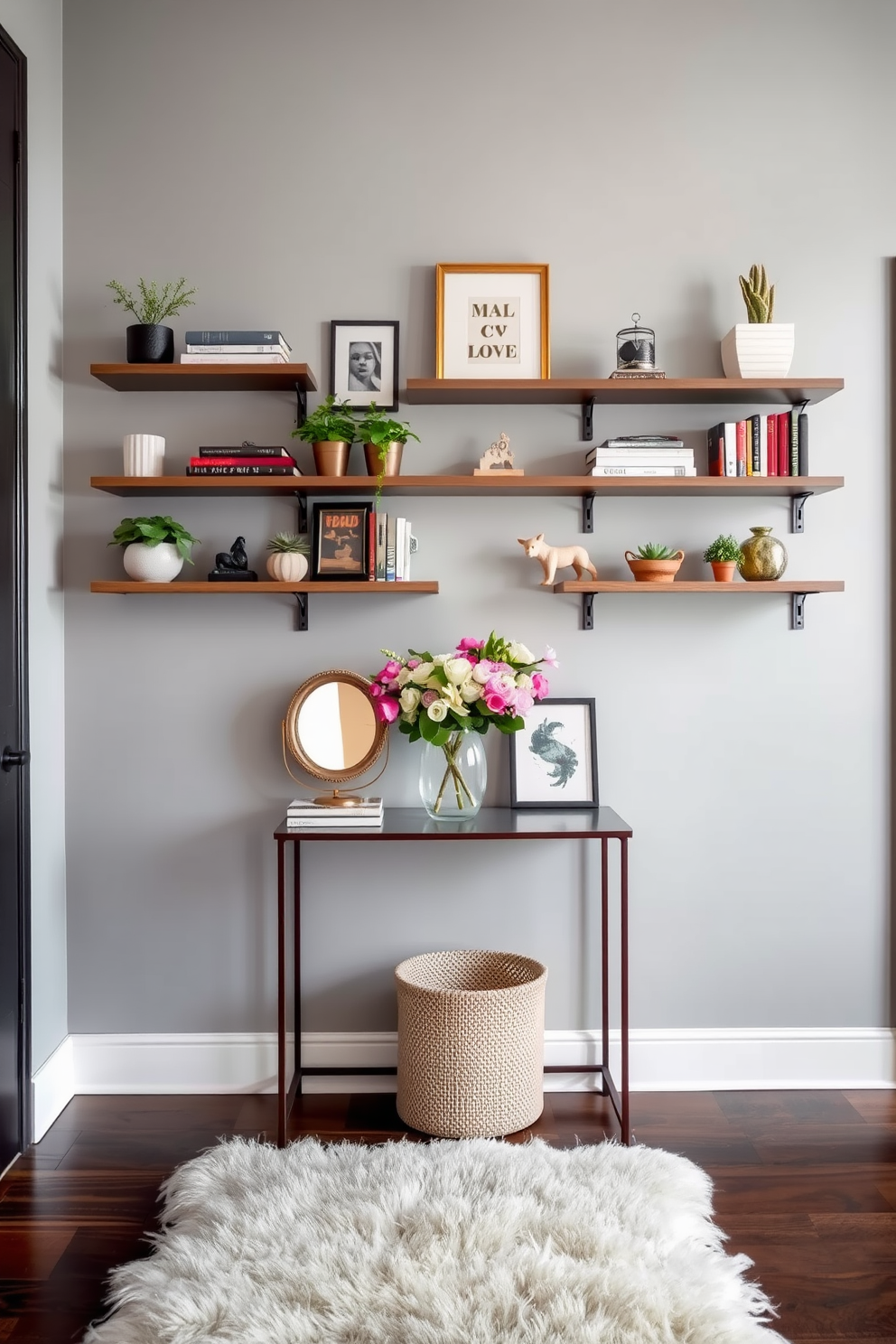 A stylish entrance foyer featuring floating shelves for decorative display. The shelves are arranged asymmetrically on a soft gray wall, adorned with a mix of plants, books, and art pieces. A welcoming atmosphere is created with a plush area rug beneath a small console table. The table holds a decorative mirror and a vase with fresh flowers, enhancing the overall elegance of the space.